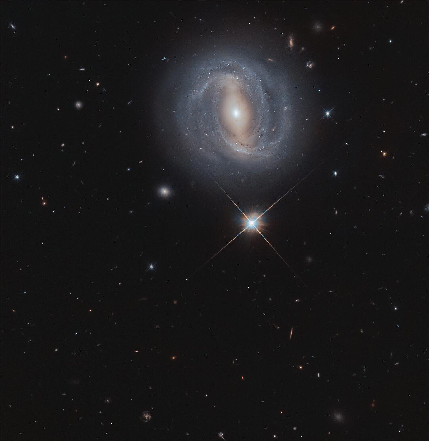 Figure 41: Shining brightly below the galaxy is a star that is actually within our own Milky Way galaxy. This star appears much brighter than the many millions of stars in NGC 4907 as it is 100,000 times closer, residing only 2500 light-years away (image credit: ESA/Hubble & NASA, M. Gregg; CC BY 4.0)