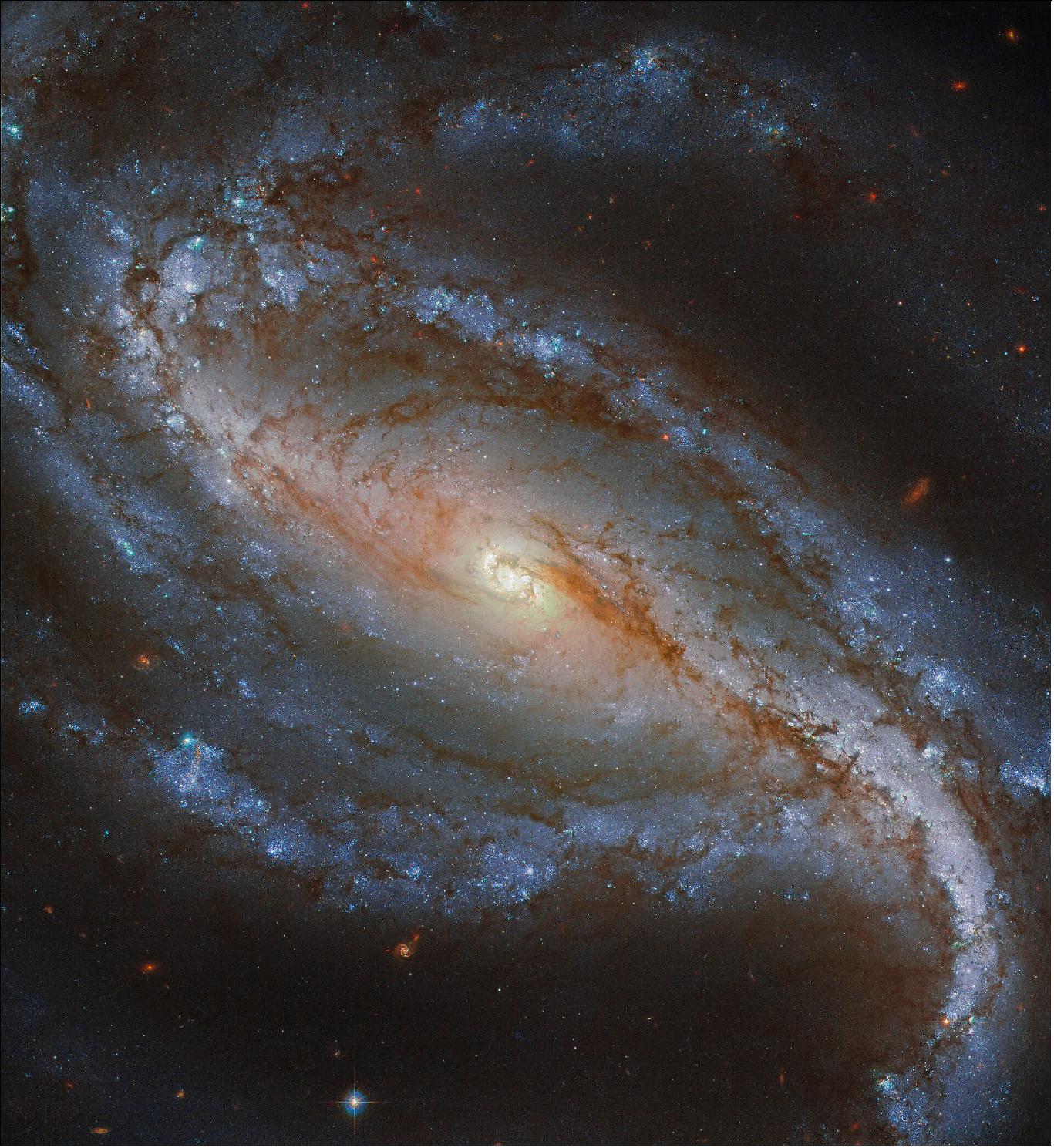 Figure 123: Featured here in a new image from the NASA/ESA Hubble Space Telescope, NGC 613 is a lovely example of a barred spiral galaxy. It is easily distinguishable as such because of its well defined central bar and long arms, which spiral loosely around its nucleus. As revealed by surveys, about two thirds of spiral galaxies, including our own Milky Way galaxy, contain a bar (image credit: ESA/Hubble & NASA, G. Folatelli; CC BY 4.0)