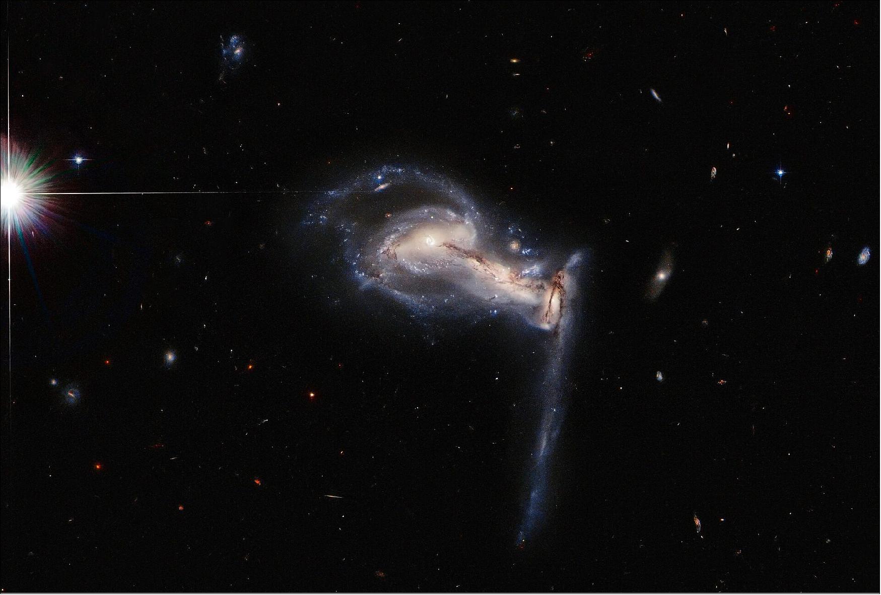 Figure 59: Observing time with the Hubble Space Telescope is extremely valuable, so astronomers don't want to waste a second. The schedule for Hubble observations is calculated using a computer algorithm which allows the spacecraft to occasionally gather bonus snapshots of data between longer observations. This image of the clashing triplet of galaxies in Arp 195 is one such snapshot. Extra observations such as these do more than provide spectacular images — they also help to identify promising targets to follow up with telescopes such as the upcoming NASA/ESA/CSA James Webb Space Telescope (image credit: ESA/Hubble & NASA, J. Dalcanton; CC BY 4.0)