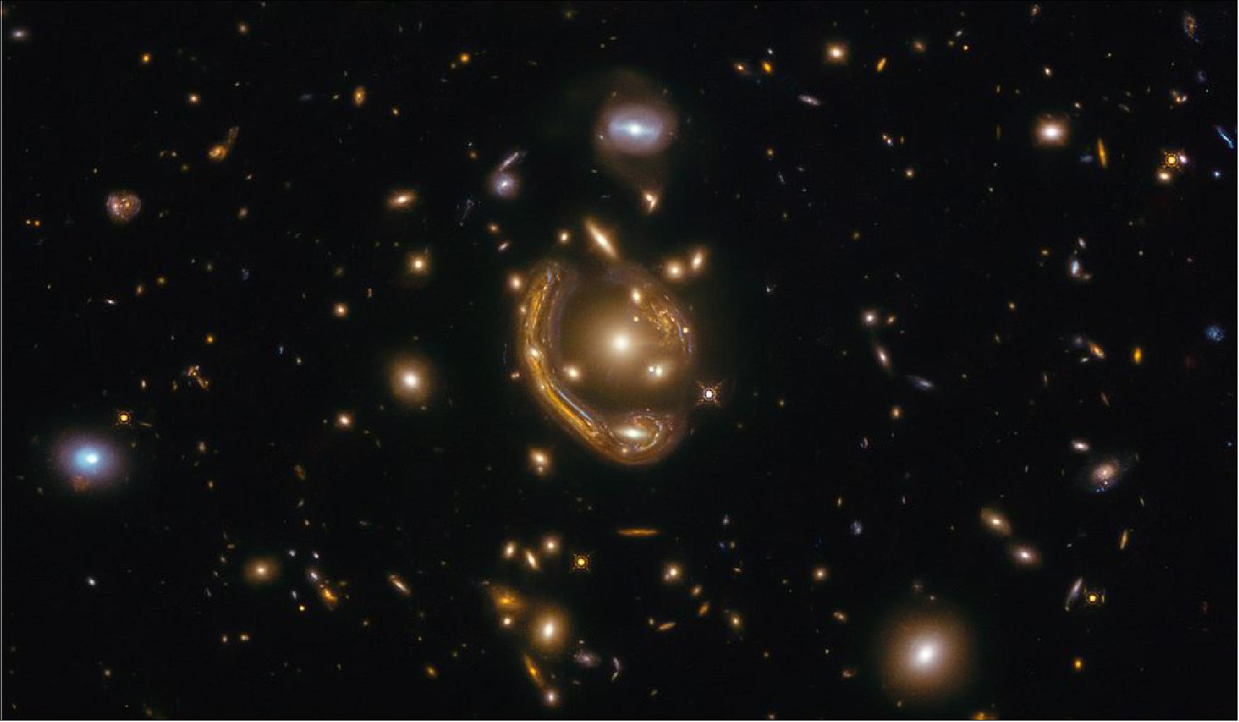 Figure 45: In this image, a remote galaxy is greatly magnified and distorted by the effects of gravitationally warped space. After its public release, astronomers used the picture to measure the galaxy's distance of 9.4 billion light-years. This places the galaxy at the peak epoch of star formation in cosmic evolution [image credit: Saurabh Jha (Rutgers, The State University of New Jersey); Release credit: NASA, ESA; Image credit: ESA/Hubble & NASA, S. Jha; Acknowledgment: L. Shatz]