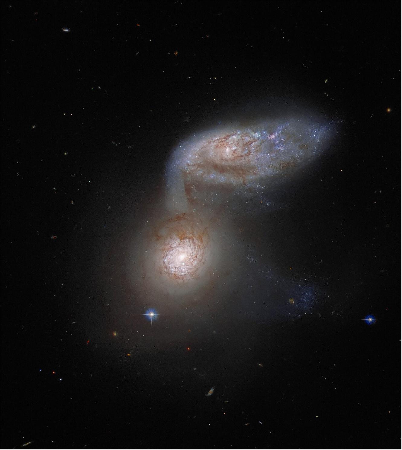 Figure 41: This Picture of the Week features two interacting galaxies that are so intertwined, they have a collective name — Arp 91. This delicate galactic dance is taking place over 100 million light-years from Earth, and was captured by the NASA/ESA Hubble Space Telescope. The two galaxies comprising Arp 91 do have their own names: the lower galaxy, which in this image looks like a bright spot, is known as NGC 5953; and the ovoid galaxy to the upper right is NGC 5954. In reality, both of these galaxies are spiral galaxies, but their shapes appear very different because they are orientated differently with respect to Earth (image credit: ESA/Hubble & NASA, J. Dalcanton; CC BY 4.0 Acknowledgement: J. Schmidt)