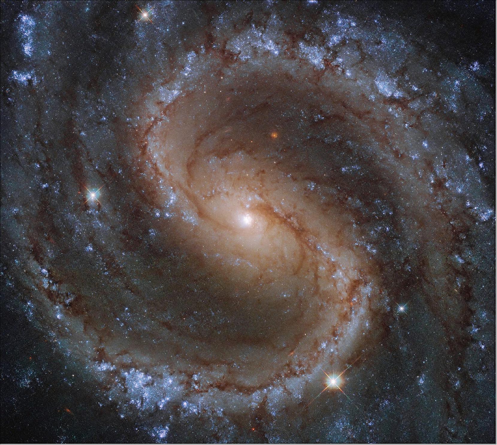Figure 120: The bright colors in this image aren't just beautiful to look at, as they actually tell us about the population of stars within this barred spiral galaxy. The bright blue-ish colors, seen nestled amongst NGC 4535's long, spiral arms, indicate the presence of a greater number of younger and hotter stars. In contrast, the yellower tones of this galaxy's bulge suggest that this central area is home to stars which are older and cooler (image credit: ESA/Hubble & NASA, J. Lee and the PHANGS-HST Team; CC BY 4.0)