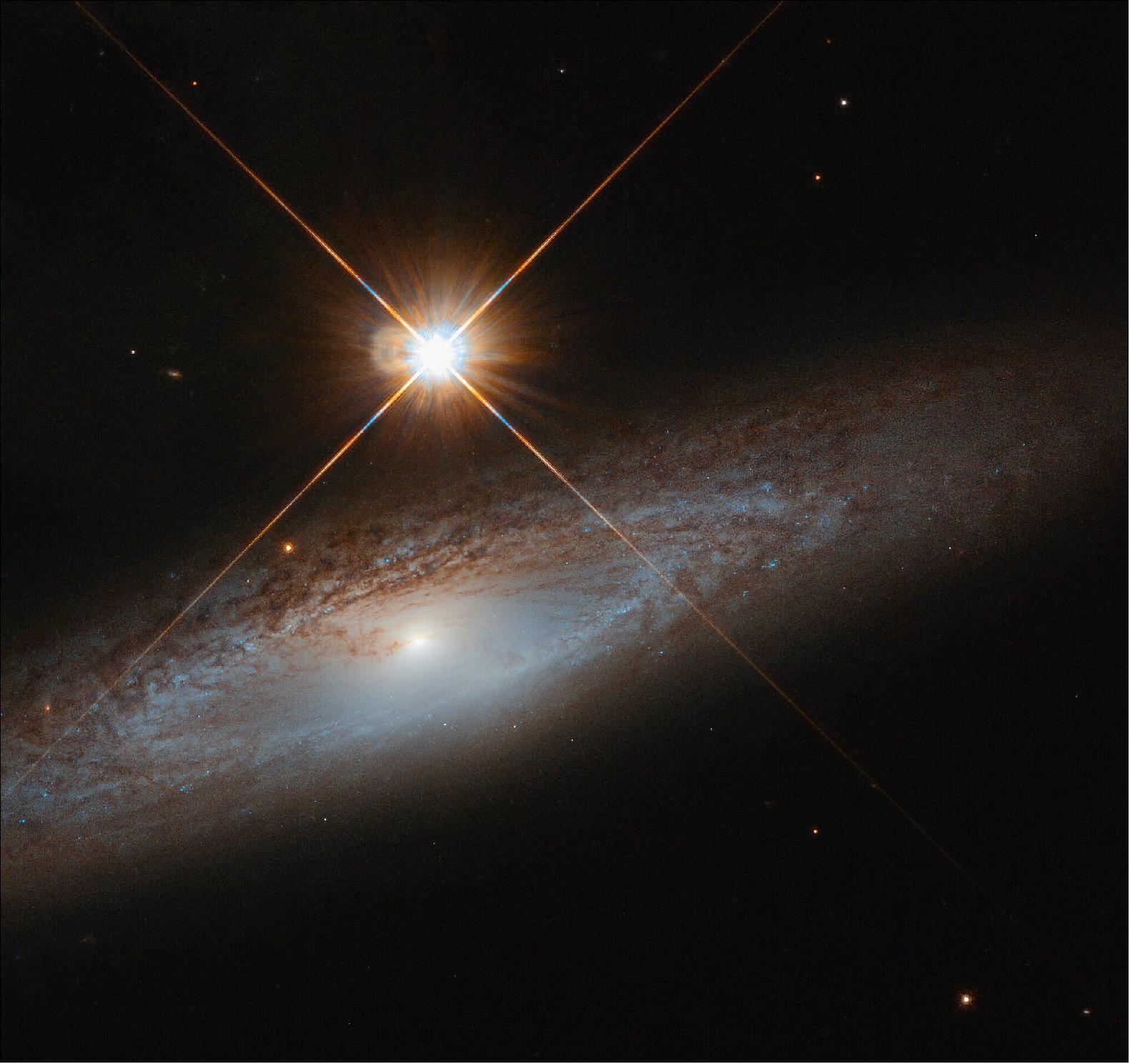 Figure 118: A bright foreground star isn't enough to distract from the grandeur of the galaxy UGC 3885, captured here by the NASA/ESA Hubble Space Telescope. While this foreground star is incredibly bright to Hubble's eye, it does not outshine the details of the background galaxy (image credit: ESA/Hubble & NASA, J. Walsh; CC BY 4.0)