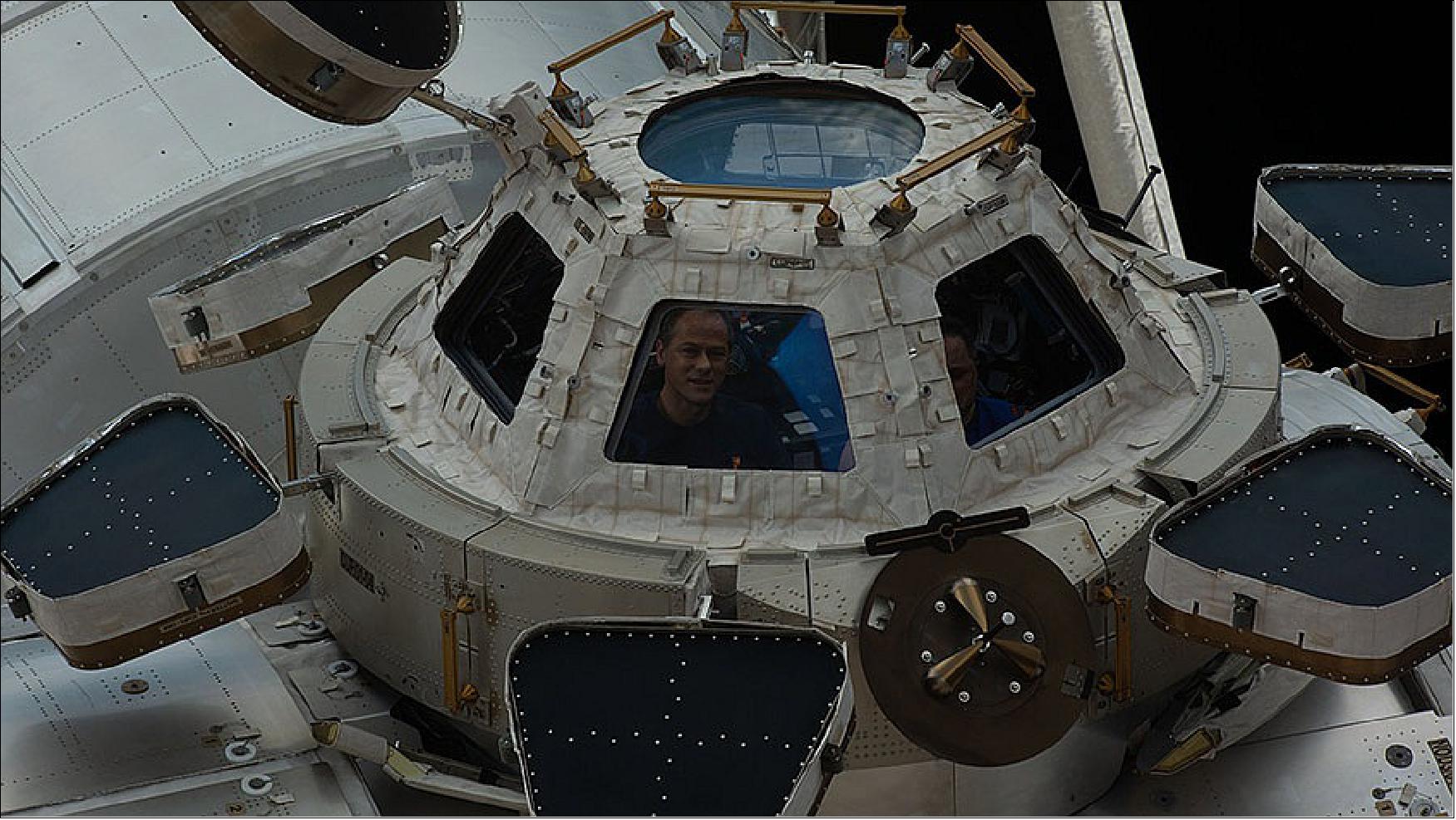 Figure 22: NASA astronaut Thomas Marshburn peers out from a window inside the cupola, the International Space Station’s “window to the world.” (image credit: NASA TV)