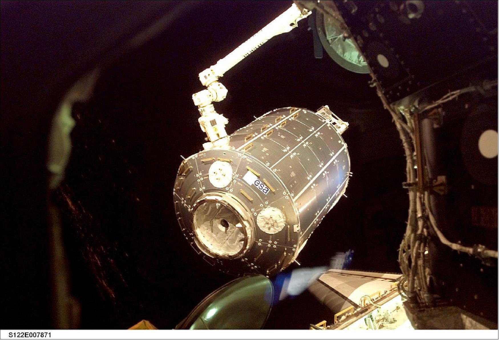Figure 26: The European Columbus laboratory is lifted out of the Shuttle payload bay, prior to attachment to the International Space Station (image credit: NASA)
