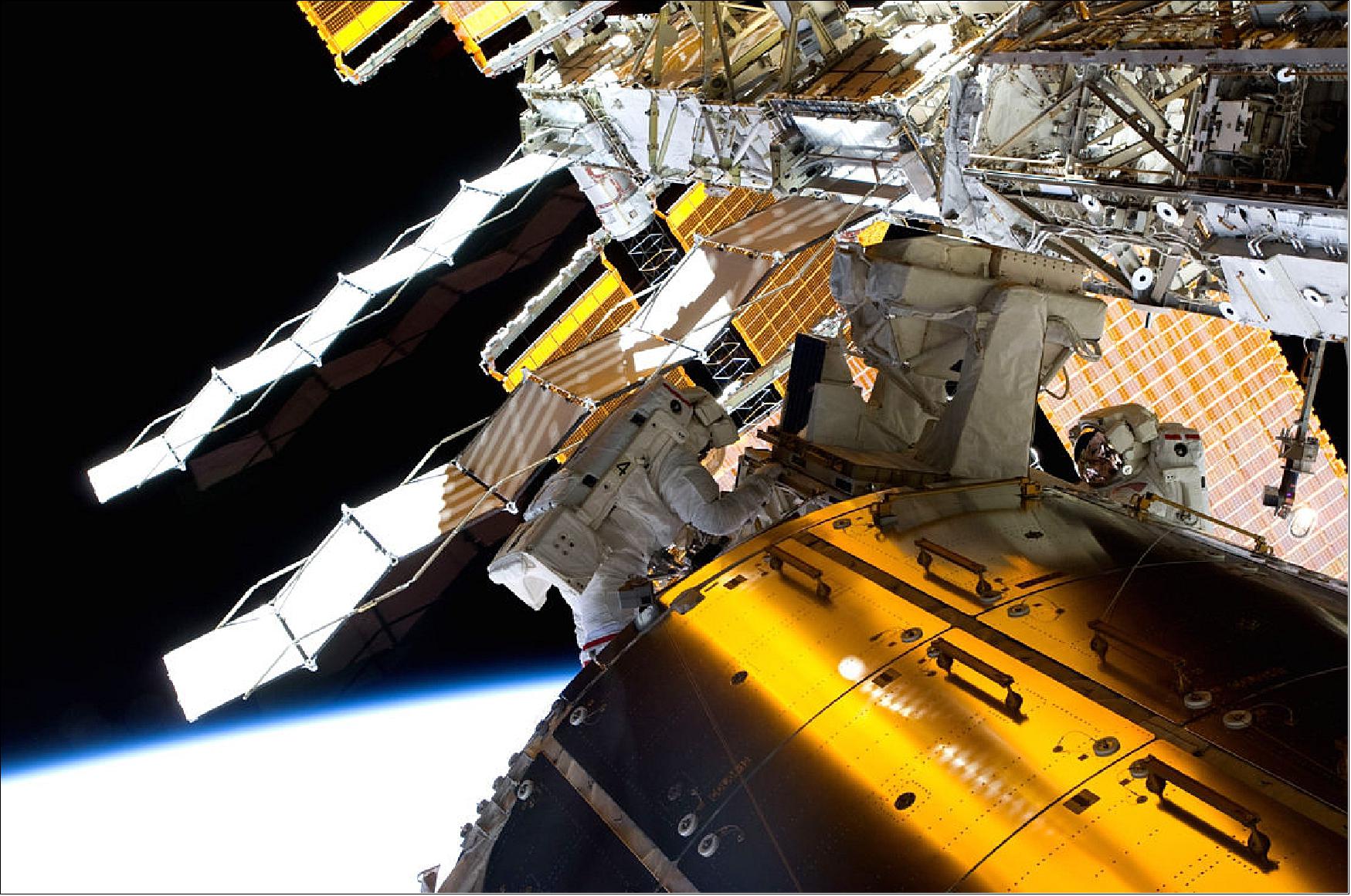 Figure 23: From fundamental physics to exobiology, the International Space Station's Columbus lab tackles big questions in space science. During the 2009 spacewalk pictured here, NASA astronauts John Olivas and Nicole Stott retrieved EUTEF (European Technology Exposure Facility), which was attached outside Columbus, for return to Earth for analysis (image credit: NASA7ESA)