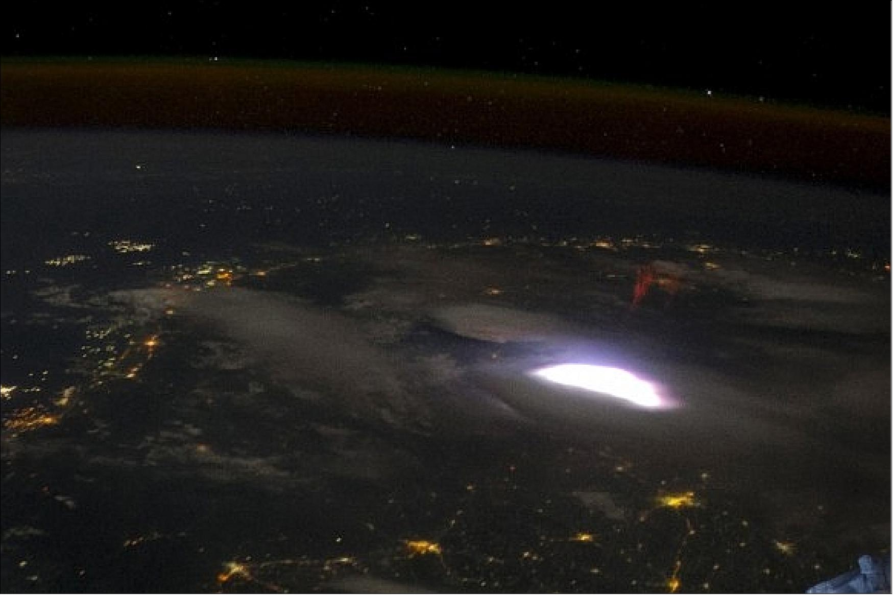 Figure 2: A bright red sprite appears above a lightning flash in a photo captured from the ISS (image credit: NASA, Universe Today)