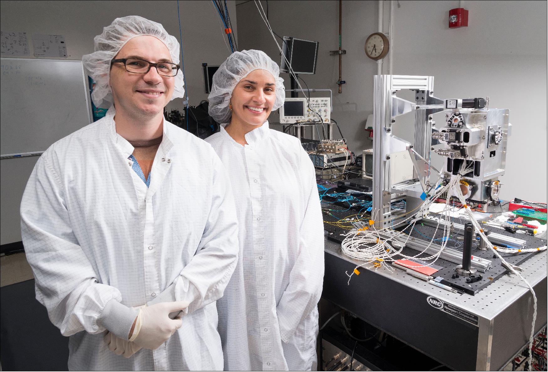 Figure 1: JPL's David Aveline and Anita Sengupta are seen with the physics package for the Cold Atom Laboratory, which includes a vacuum chamber where ultra-cold quantum gases are made (image credit: NASA/JPL-Caltech)