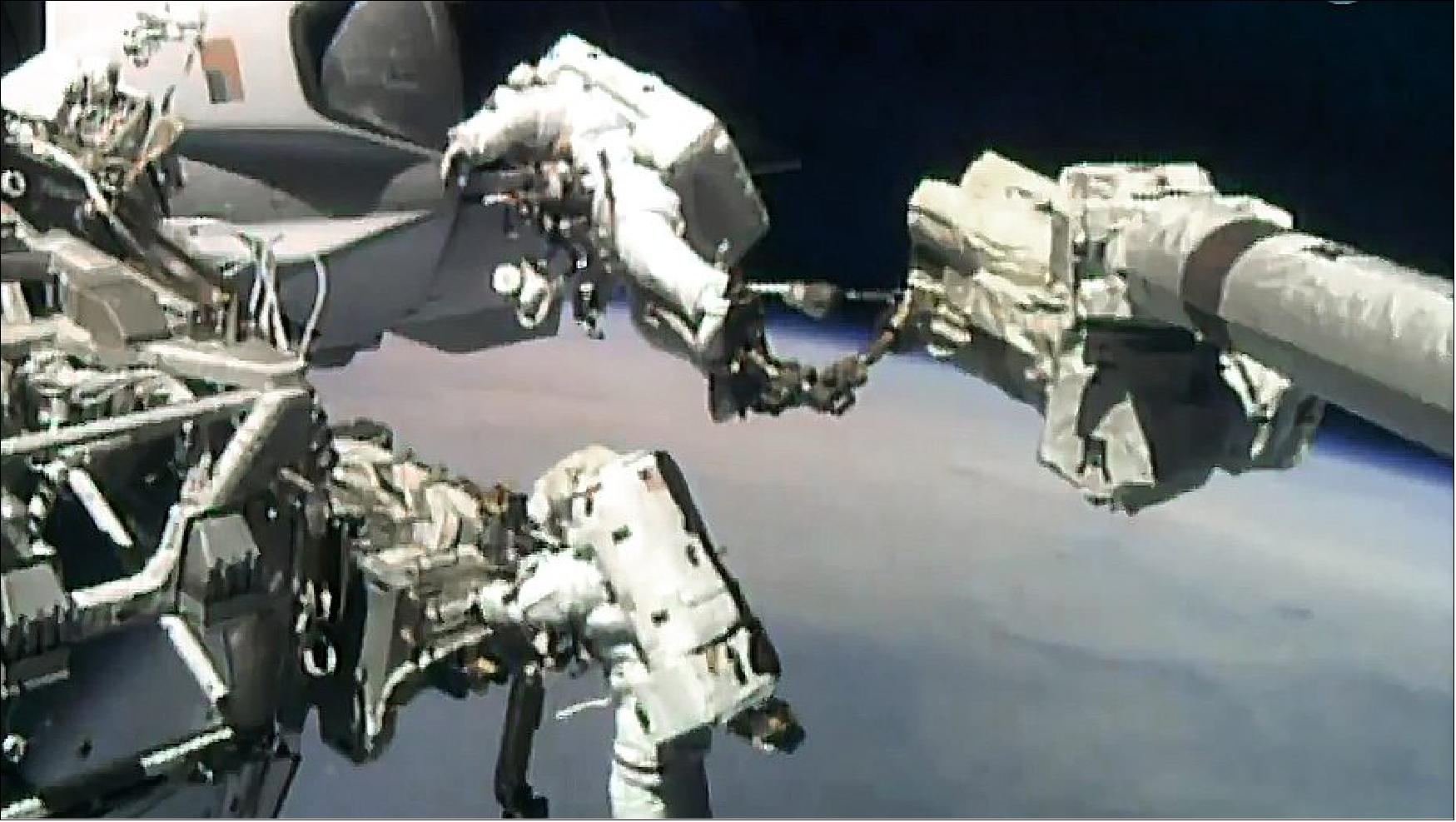 Figure 10: Spacewalkers Victor Glover (top) and Michael Hopkins are pictured working on upgrades to the Bartolomeo science platform attached to Europe’s Columbus lab module (image credit: NASA TV)