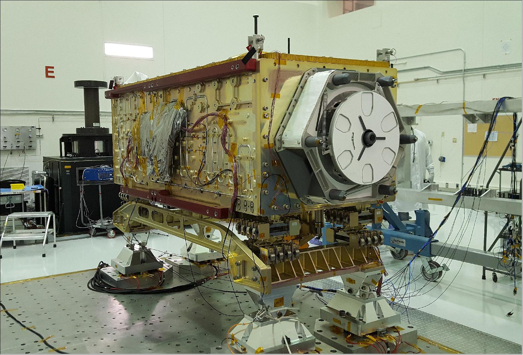 Figure 15: OCO-3 sits on the large vibration table (known as the "shaker") in the Environmental Test Lab at the Jet Propulsion Laboratory. The exposed wires lead to sensors used during dynamics and thermal-vacuum testing. Thermal blankets will be added to the instrument at Kennedy Space Center, where a Space-X Dragon capsule carrying OCO-3 will launch in on a Falcon 9 rocket to the space station on May 1, 2019 (image credit: NASA/JPL-Caltech) 18)