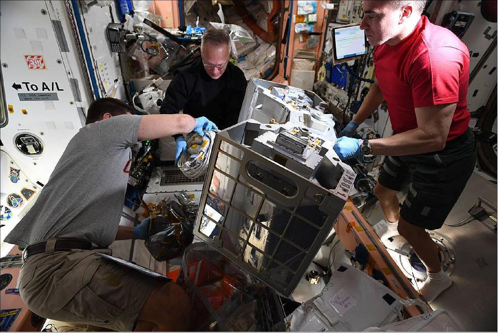 Figure 8: Astronauts Robert Behnken, Doug Hurley, and Chris Cassidy prepare RiTS for installation (image credit: NASA)