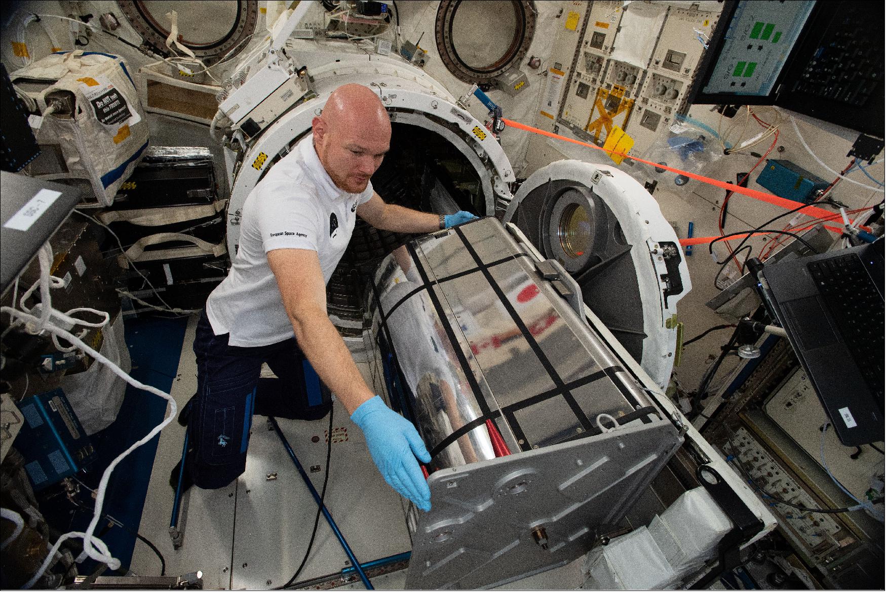 Figure 81: ESA astronaut Alexander Gerst preparing the DESIS instrument for installation aboard the space station. The DESIS instrument works by measuring hyperspectral reflections from Earth's surface which contributes to resource management, ecosystem health monitoring and urban development (image credit: NASA)