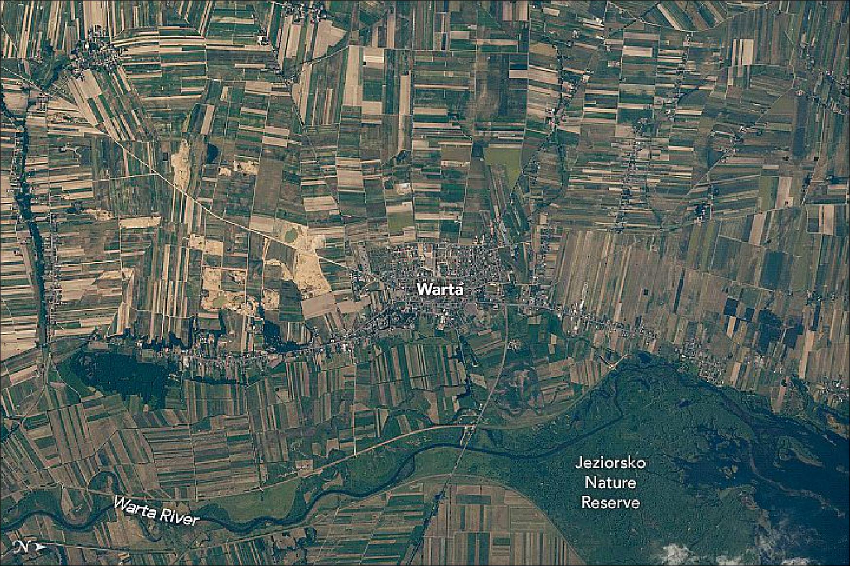 Figure 79: Narrow, rectangular farm plots with historic roots spread across the landscape near Warta. The astronaut photograph ISS048-E-7144 was acquired on June 26, 2016, with a Nikon D4 digital camera using an 800 millimeter lens and is provided by the ISS Crew Earth Observations Facility and the Earth Science and Remote Sensing Unit, Johnson Space Center. The image was taken by a member of the Expedition 48 crew (image credit: NASA Earth Observatory, caption by Sara Schmidt)