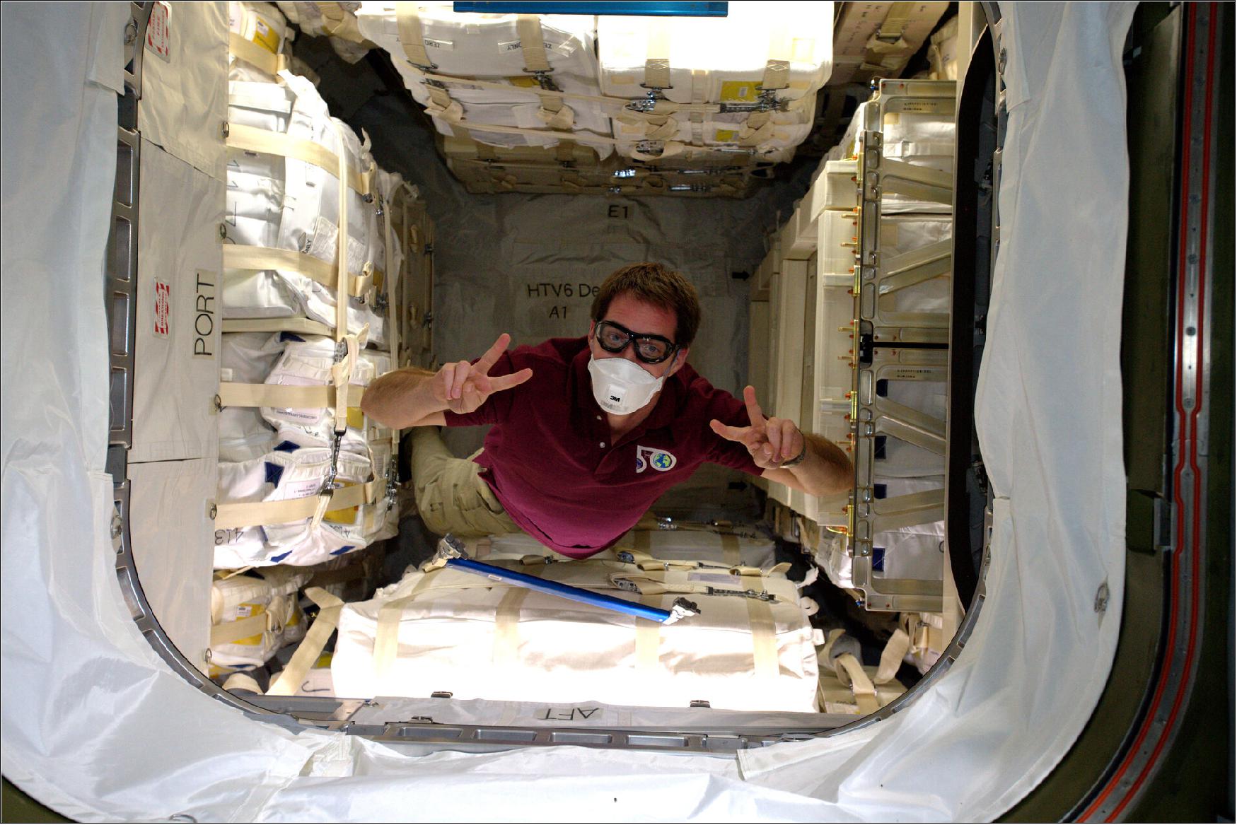 Figure 75: Thomas wrote this caption for the image: "This is what the inside of the HTV looks like. 2600 kg of science, equipment and supplies, very neatly packed and strapped to resist a launch to space! For first ingress into a cargo vehicle – after we equalize the pressure and open the hatch – we always wear a mask and take samples of the atmosphere. Safety first! Some dust or small debris could have gotten loose and become a hazard for the crew, and the atmosphere might be somehow polluted. Not the case with our pristine HTV-6!"(image credit: ESA/NASA)