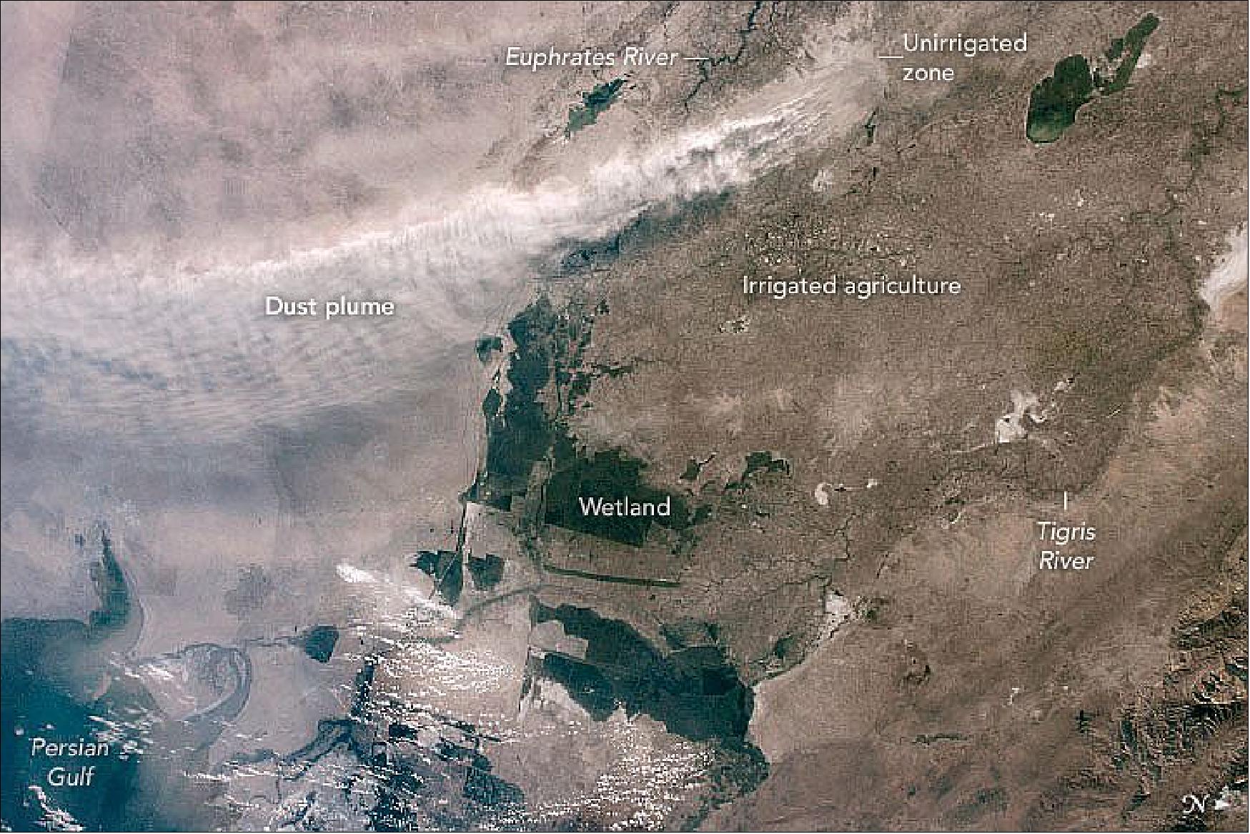 Figure 38: This photo was taken just over a minute later. It shows that the dust plume was rising from a relatively small patch of lighter-toned ground near the Euphrates River. This patch of desert lacks irrigation canals and is quite bare of vegetation. The surrounding landscapes are darker-toned because they are covered with croplands (irrigated with water from the Tigris and Euphrates rivers), as well as some wetlands and dark-toned reservoirs. No plumes rose from these areas, where the effects of irrigation—wet soils and crop growth—protect the surface from wind erosion (image credit: NASA Earth Observatory)