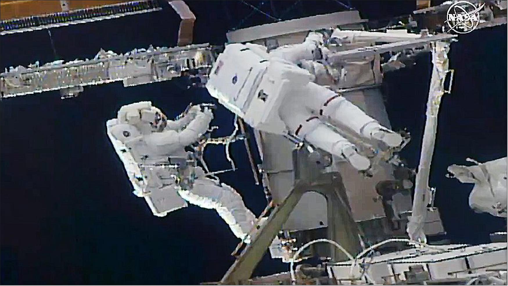 Figure 117: From left: Astronauts Soichi Noguchi and Kate Rubins work to install a solar array modification kit during the fourth spacewalk of 2021 (image credit: NASA)