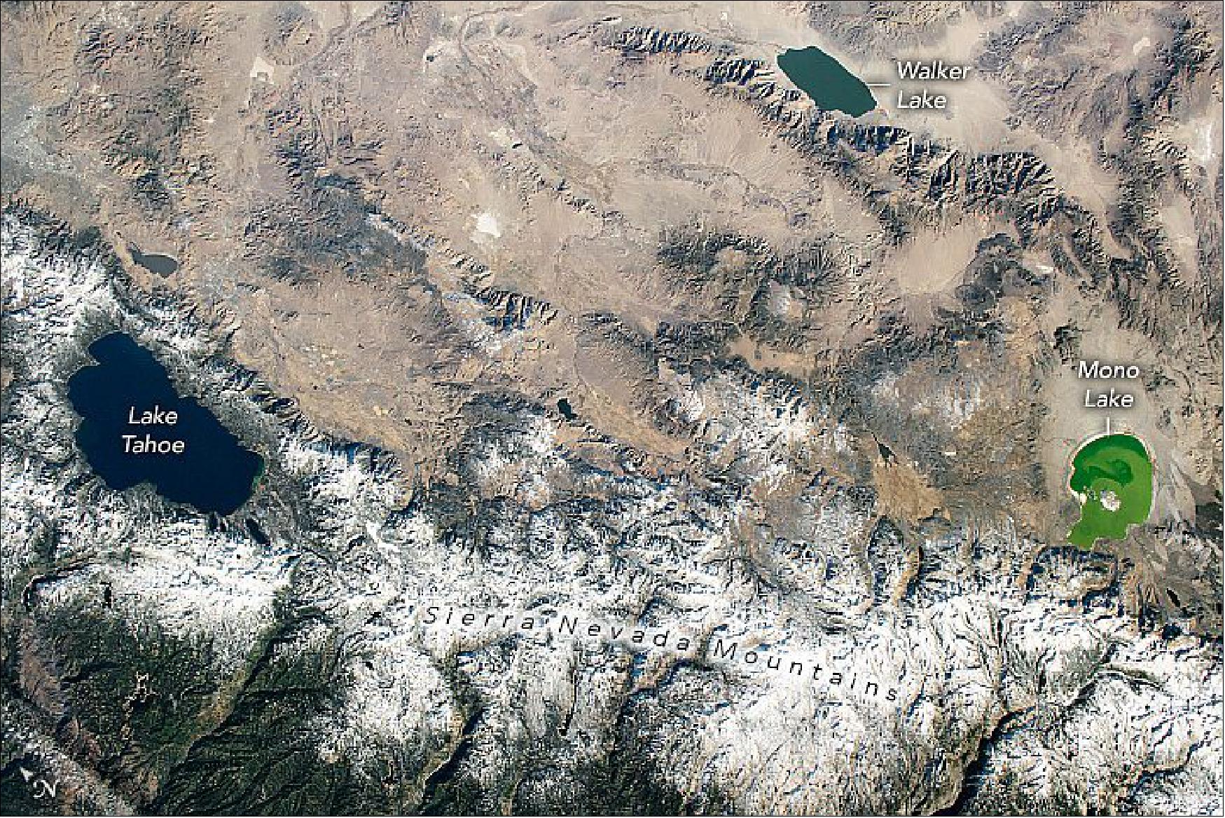 Figure 101: An astronaut captured this view of three basins—Tahoe, Walker, and Mono—straddling two different climates. This photograph ISS064-E-9397 was acquired on December 3, 2020, with a Nikon D5 digital camera using a 78 mm lens and is provided by the ISS Crew Earth Observations Facility and the Earth Science and Remote Sensing Unit, Johnson Space Center. The image was taken by a member of the Expedition 64 crew. The image has been cropped and enhanced to improve contrast, and lens artifacts have been removed (image credit: NASA Earth Observatory, caption by Laura Phoebus)