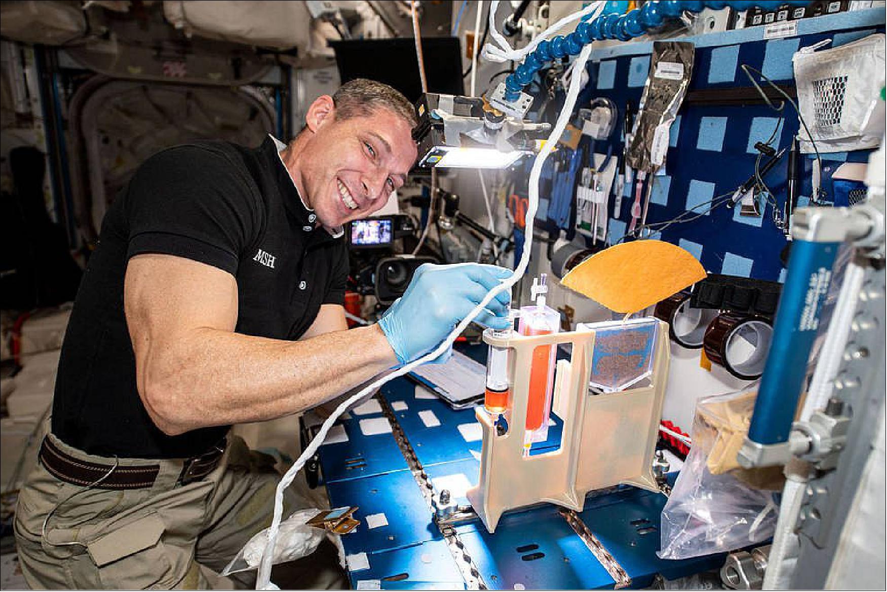 Figure 82: Astronaut Mike Hopkins works with the PWM hydroponics test cell on the space station (image credit: NASA)