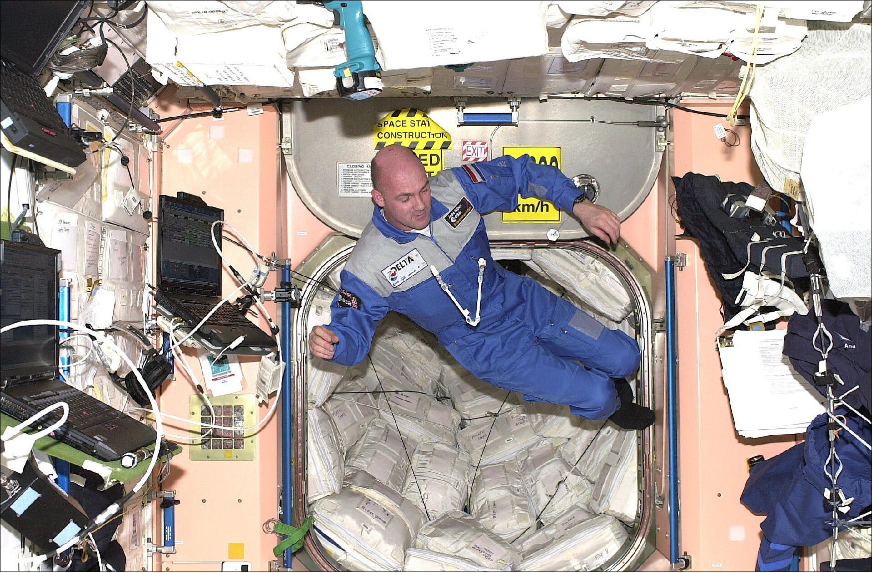 Figure 69: ESA astronaut André Kuipers is seen in this picture during his first space mission in 2004, with a scale model of the European Robotic Arm on his chest. The real thing has a length of over 11 m, and has the ability to anchor itself to the Station in multiple locations, moving backwards and forwards with a large range of motion (image credit: ESA/NASA)
