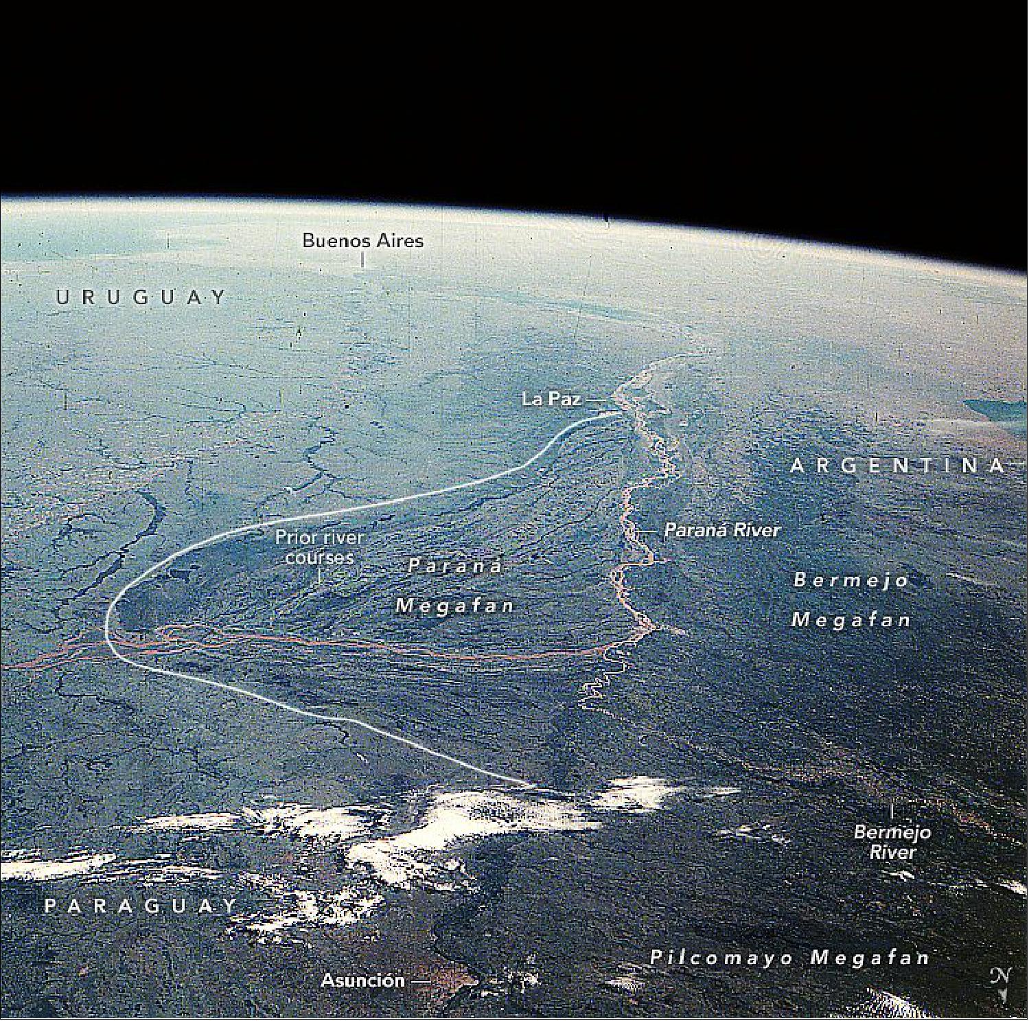 Figure 44: Though 36 years old, this photo remains one of the best for demonstrating vast inland delta landscapes. The photo was taken with a Hasselblad film camera—common in the days before astronauts switched to digital cameras—and before wide views were easily obtainable from the International Space Station. It remains one of the best images to demonstrate megafan landscapes. Two other megafans are partly visible: the lower 100 km (60 miles) of the Pilcomayo and Bermejo megafans. The Pilcomayo megafan is the largest on the planet at 705 km in length (image credit: The astronaut photograph STS51D-46-22 was acquired on April 18, 1985, with a Hasselblad film camera using a focal length of 100 mm. It is provided by the ISS Crew Earth Observations Facility and the Earth Science and Remote Sensing Unit, Johnson Space Center. The image was taken by a member of the STS-51D crew. The image has been cropped and enhanced to improve contrast, and lens artifacts have been removed (image credit: NASA Earth Observatory, caption by Justin Wilkinson)