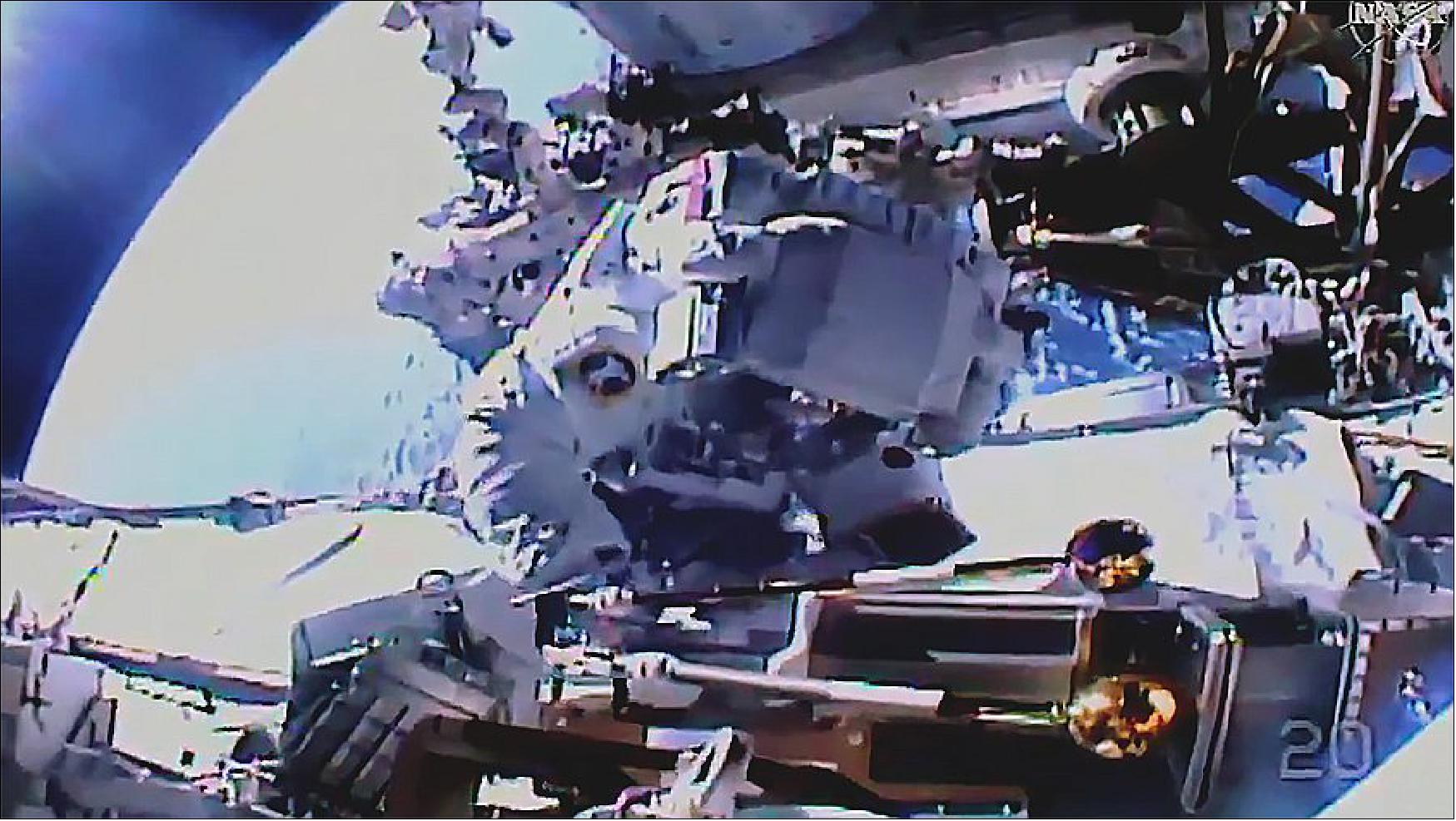 Figure 43: Spacewalker Akihiko Hoshide works on the station's Port-4 truss structure installing a modification kit and preparing it for a future Roll-Out Solar Array. Credit: NASA TV (image credit: NASA TV)