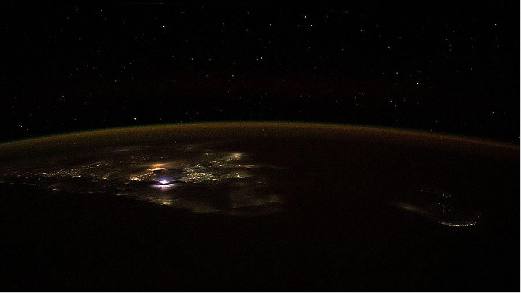 Figure 16: The city lights of southern India and the island nation of Sri Lanka, beneath the Earth's airglow, are pictured from the station as it orbited above the Indian Ocean (image credit: NASA)