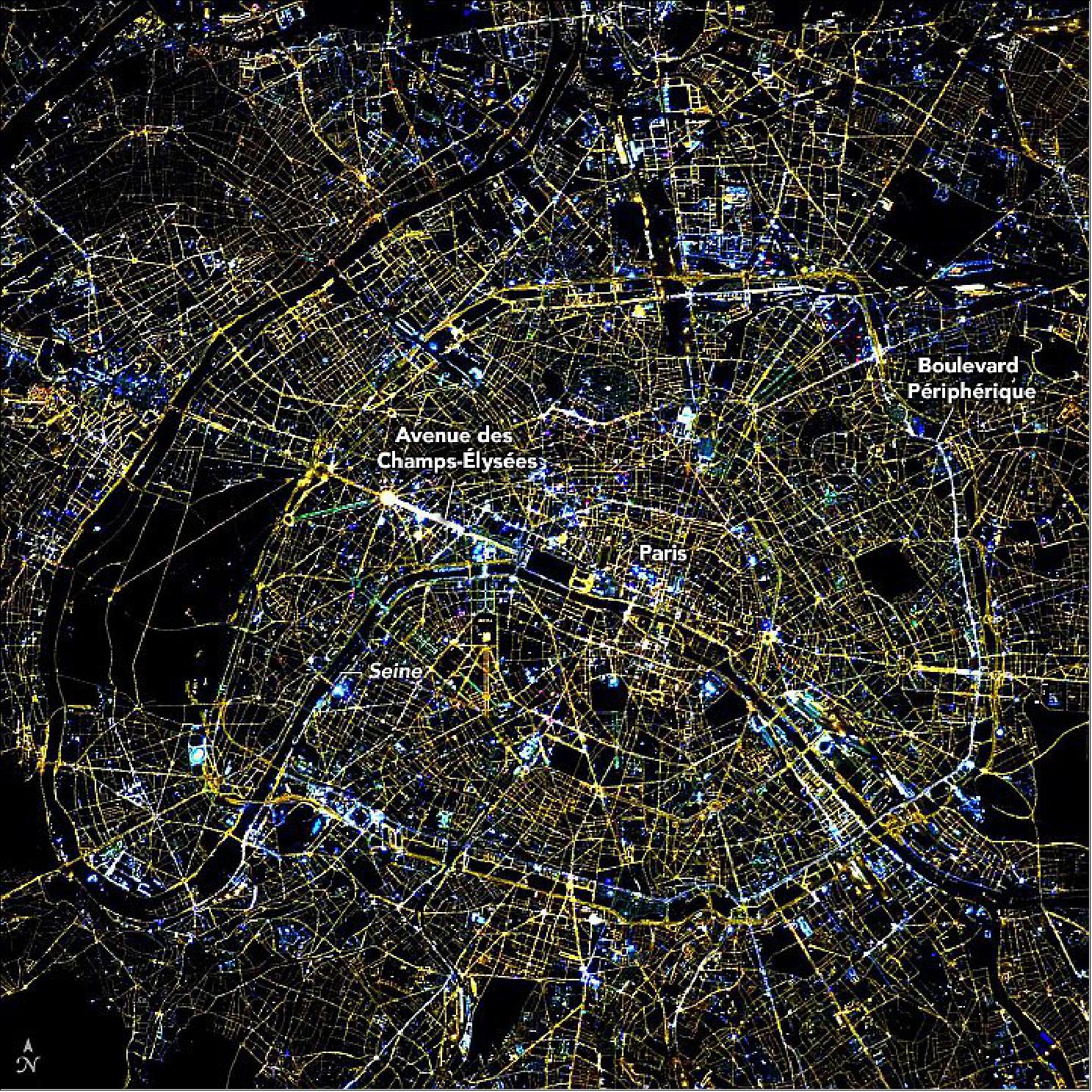 Figure 10: The ISS photographs of Paris (Figure 10) and Kuwait City (Figure 11) have been calibrated to a color temperature of 2200 Kelvin, typical of high-pressure sodium lights. These two cities display very different color and spatial configurations. Light in Paris comes almost entirely from streetlights—primarily yellow, but also blue and green. Avenue des Champs-Elysées appears white, likely because the brightness of the street lights and buildings saturated this part of the image. "Paris is probably the best example of the diversity of colors and spatial configurations that we are trying to quantify," Small said (image credit: NASA Earth Observatory)
