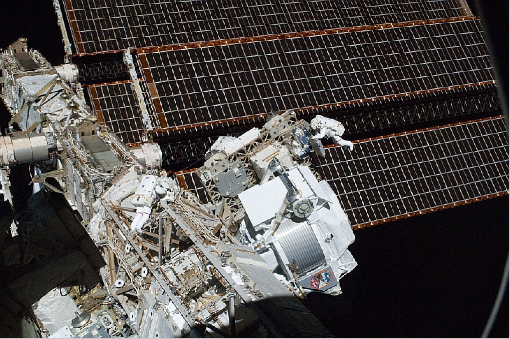 Figure 33: Photo of the installed AMS-02 with astronauts Andrew Feustel (right) and Greg Chamitoff (left middle on the truss) during a 6 hr 19 min EVA on May 20, 2011, (image credit: NASA, ESA, Ref. 68)