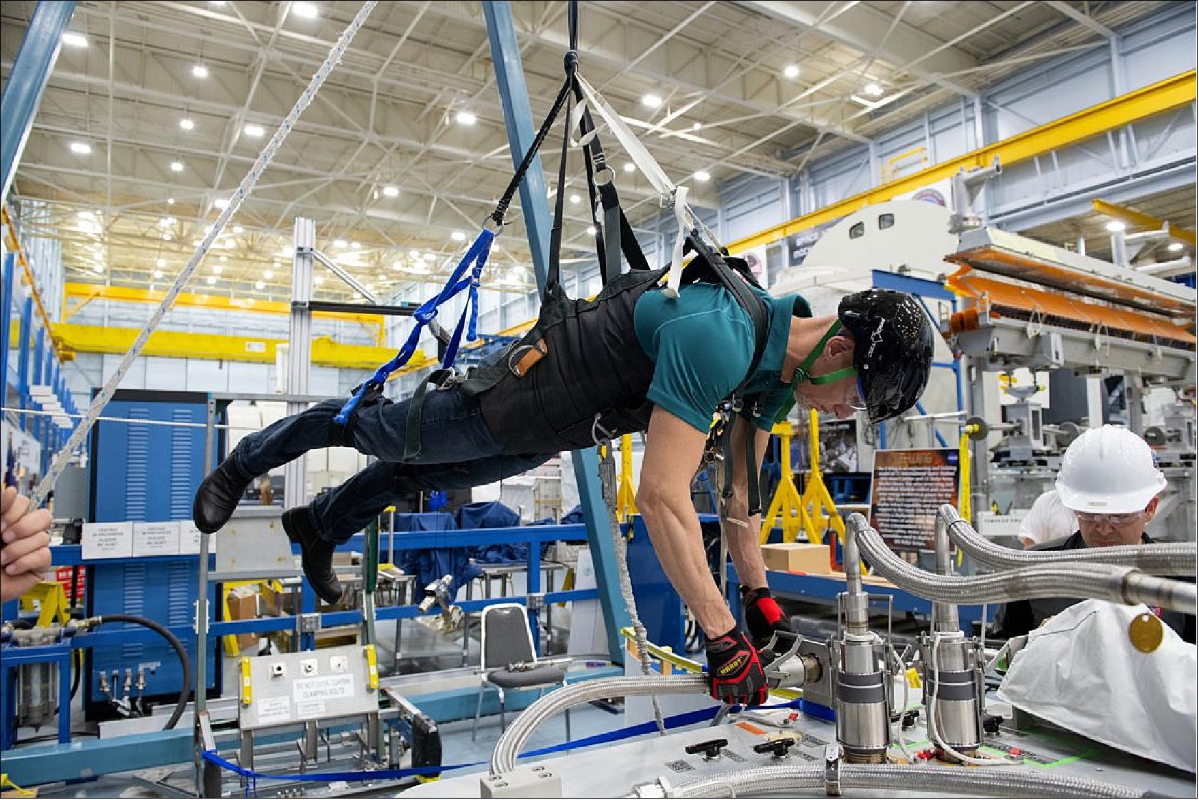 Figure 11: In preparation for his 'Beyond' mission, ESA astronaut Luca Parmitano was at the Johnson Space Center in Houston, USA, in March 2019. Here he is strapped to the Partial Gravity Simulator to practice repairing the dark-matter hunter AMS-02 (image credit: ESA, S. Corvaja)