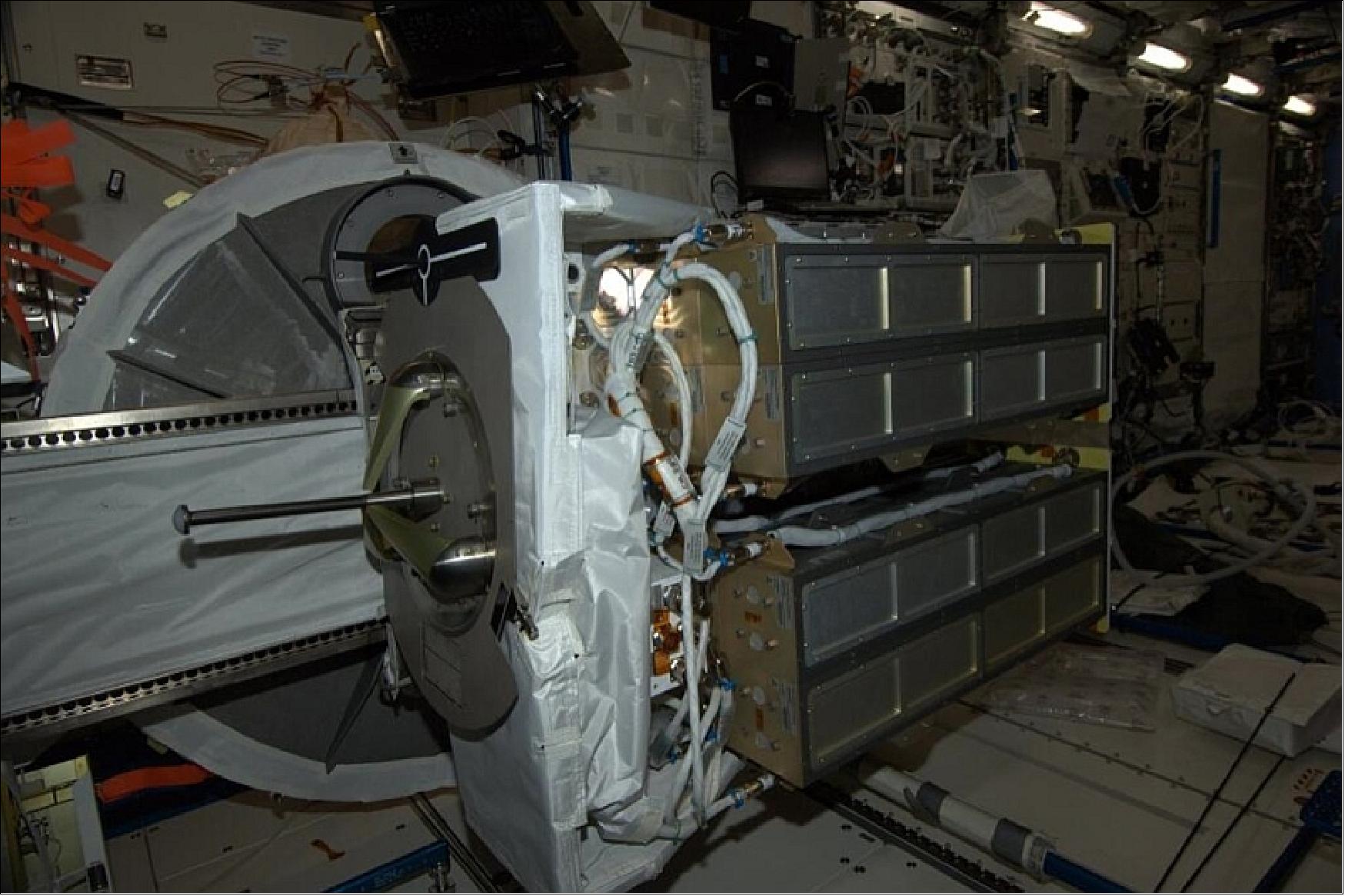 Figure 37: The Flock 1A nanosatellites are prepared for deployment on board the ISS. The photo shows four NRCSDs (NanoRacks CubeSat Deployers), each containing two Doves (image credit: Astronaut Koichi Wakata)