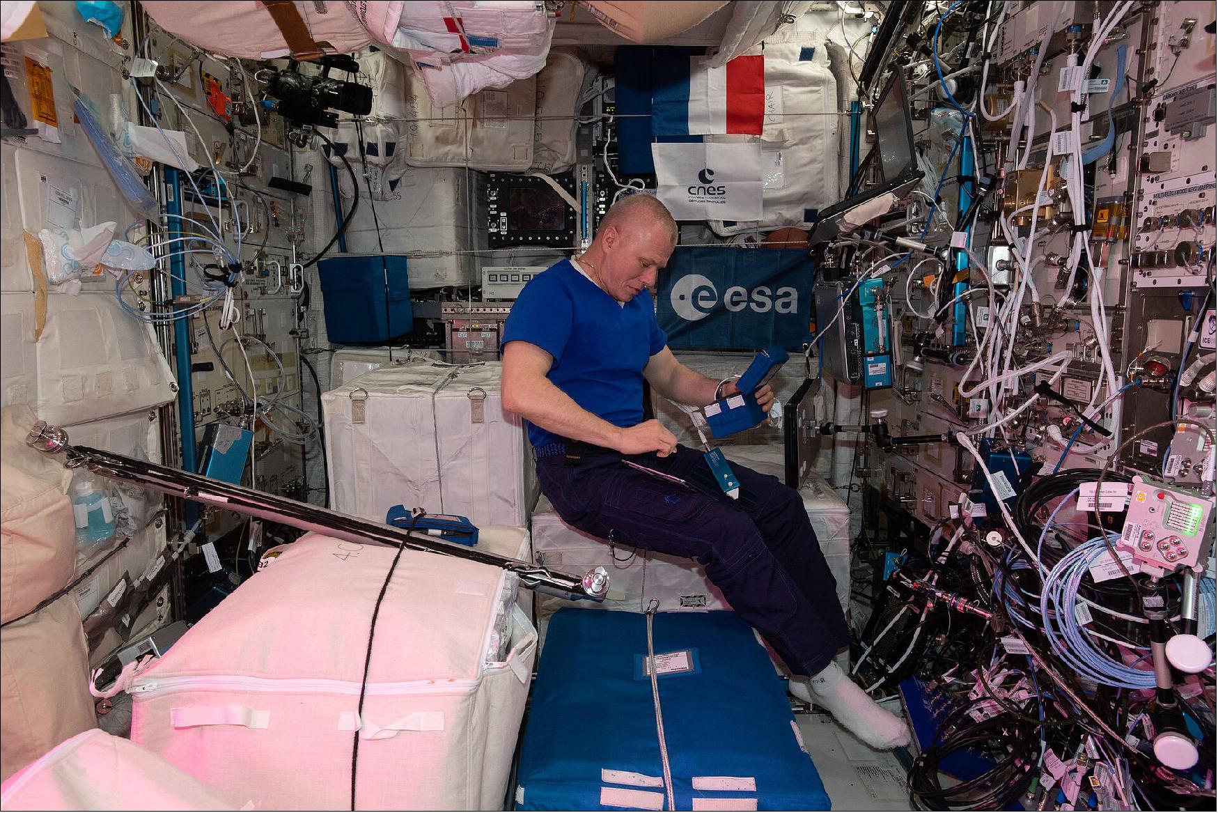 Figure 2: Roscosmos cosmonaut Oleg Novitsky working on the Plasma Kristall-4 experiment in Europe's Columbus laboratory on the International Space Station, 18 June 2021 (image credit: ESA/NASA–T. Pesquet)
