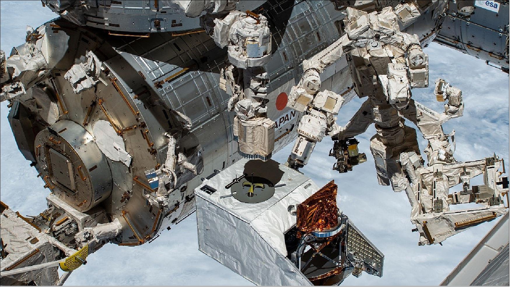 Figure 6: Shown here is the hand-off of the H-8 payload between the NASA’s Special Purpose Dexterous Manipulator (SPDM) and the Japanese Experiment Module Remote Manipulator: the SPDM has the STP-H8 payload by the H-fixture and the JEMRMS is shown descending to grab the Fixed Releasable Grapple Fixture (FRGF), photo courtesy of NASA