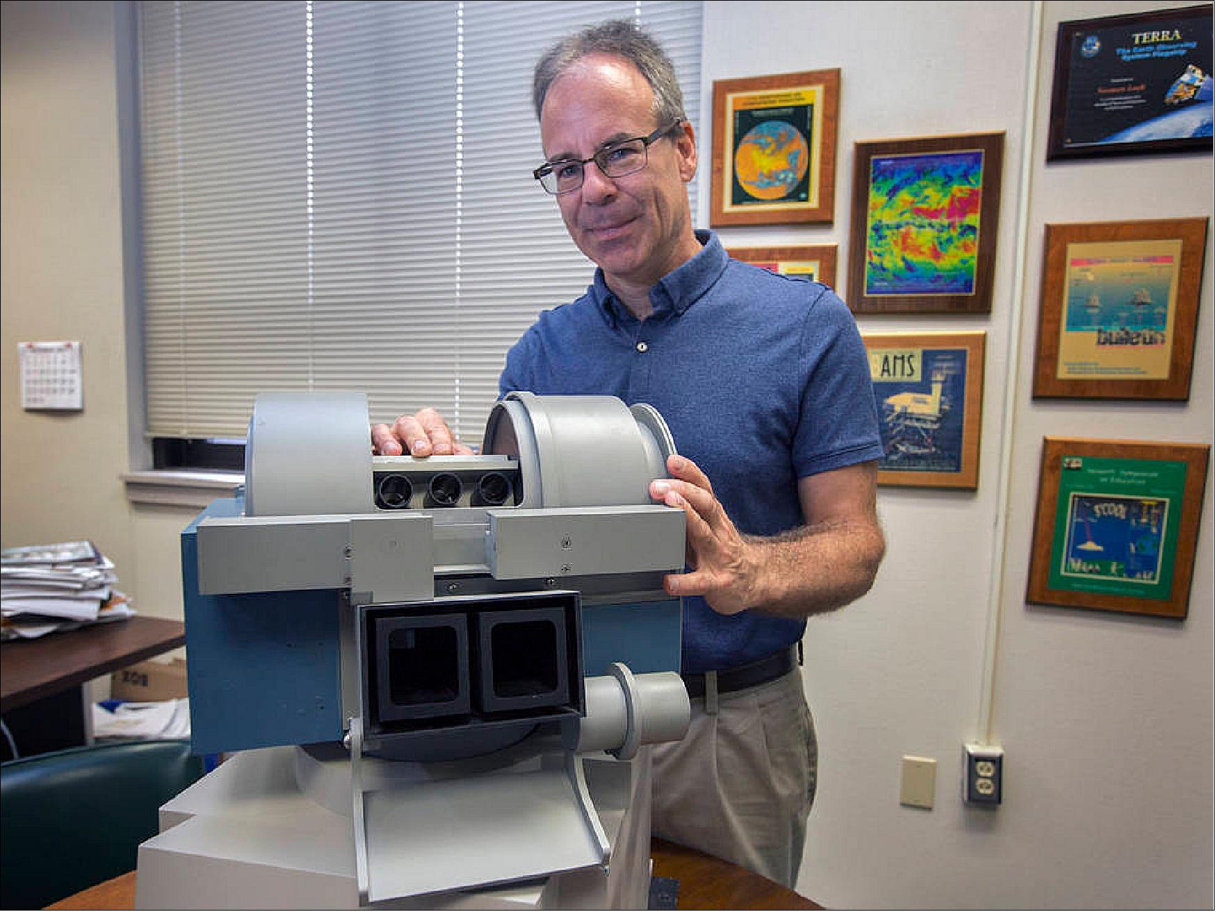 Figure 59: Norman Loeb, principal investigator of NASA’s Radiation Budget Science Project, is pictured with a CERES model, which studies the clouds and monitor Earth's “energy budget” (image credit: NASA, David C. Bowman) 97)