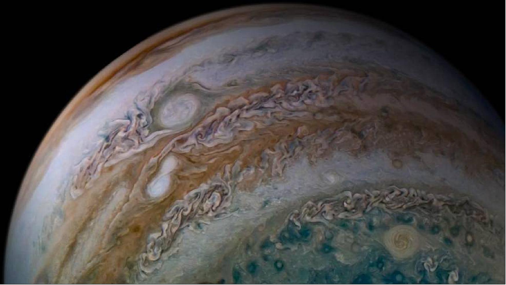 Figure 23: This view from the JunoCam imager on NASA's Juno spacecraft shows two storms merging. The two white ovals seen within the orange-colored band left of center are anticyclonic storms – that is, storms that rotate counterclockwise. The image was taken on Dec. 26, 2019 (image credits: NASA/JPL-Caltech/SwRI/MSSS Image processing by Tanya Oleksuik, © CC BY)