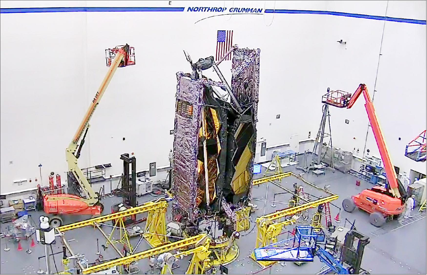 Figure 31: A first look at NASA's James Webb Space Telescope fully stowed into the same configuration it will have when loaded into an Ariane V rocket for launch. The image was taken from a webcam in the clean room at Northrop Grumman, in Redondo Beach, California. With staffing restrictions in place due to COVID-19, only essential staff are allowed in the clean room (image credit: Northrop Grumman)