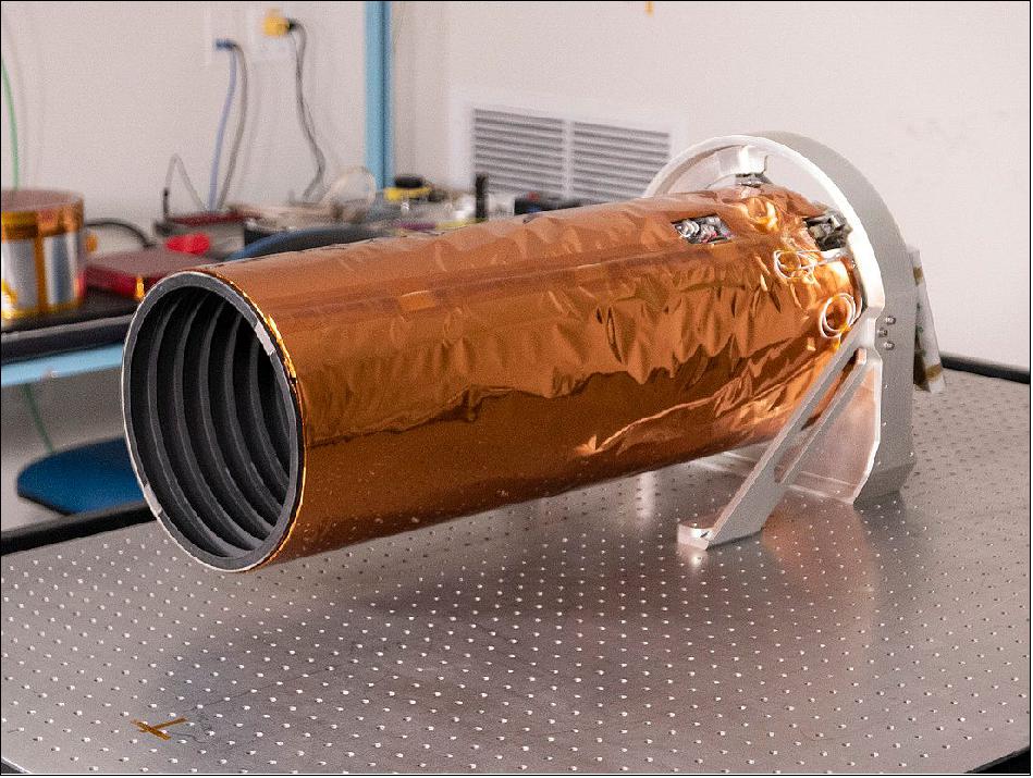 Figure 12: The rings inside the ShadowCam sunshade (left side) were designed to reduce stray light from making its way to the detector, which could otherwise overwhelm the dim signal from shadowed regions while capturing images. The orange material is a thermal blanket that protects the telescope and sunshade from the harsh space environment (image credit: ASU)