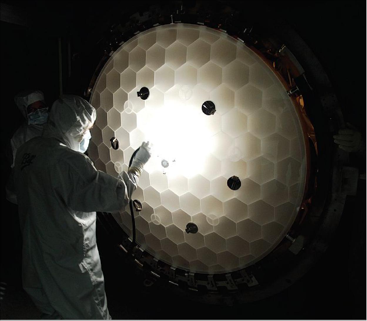 Figure 9: Inspection of the 1.4 meter primary mirror honeycomb structure. The mirror has been 86% light weighted, and only weighs 14% of a solid mirror of the same dimensions (image credit: NASA, Kepler Team)