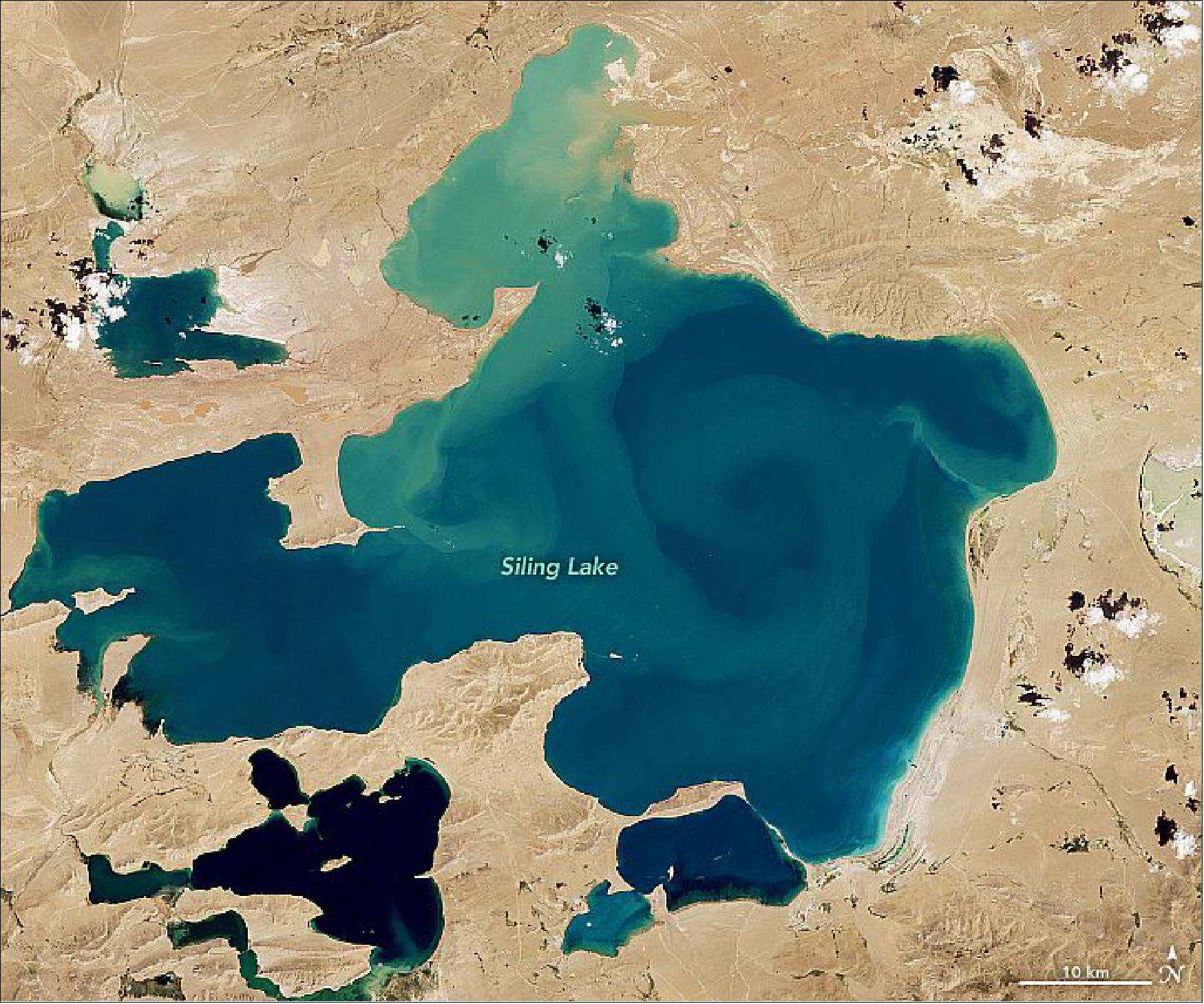 Figure 76: Siling Lake (or Sèlin Cuò) in Tibet is one lake that has had a steady increase in blooming intensity since 1995. This natural-color image was acquired by the Operational Land Imager on Landsat-8 on September 12, 2017 (image credit: NASA Earth Observatory, images by Lauren Dauphin, using Landsat data from the U.S. Geological Survey. Story by Andi Brinn Thomas)