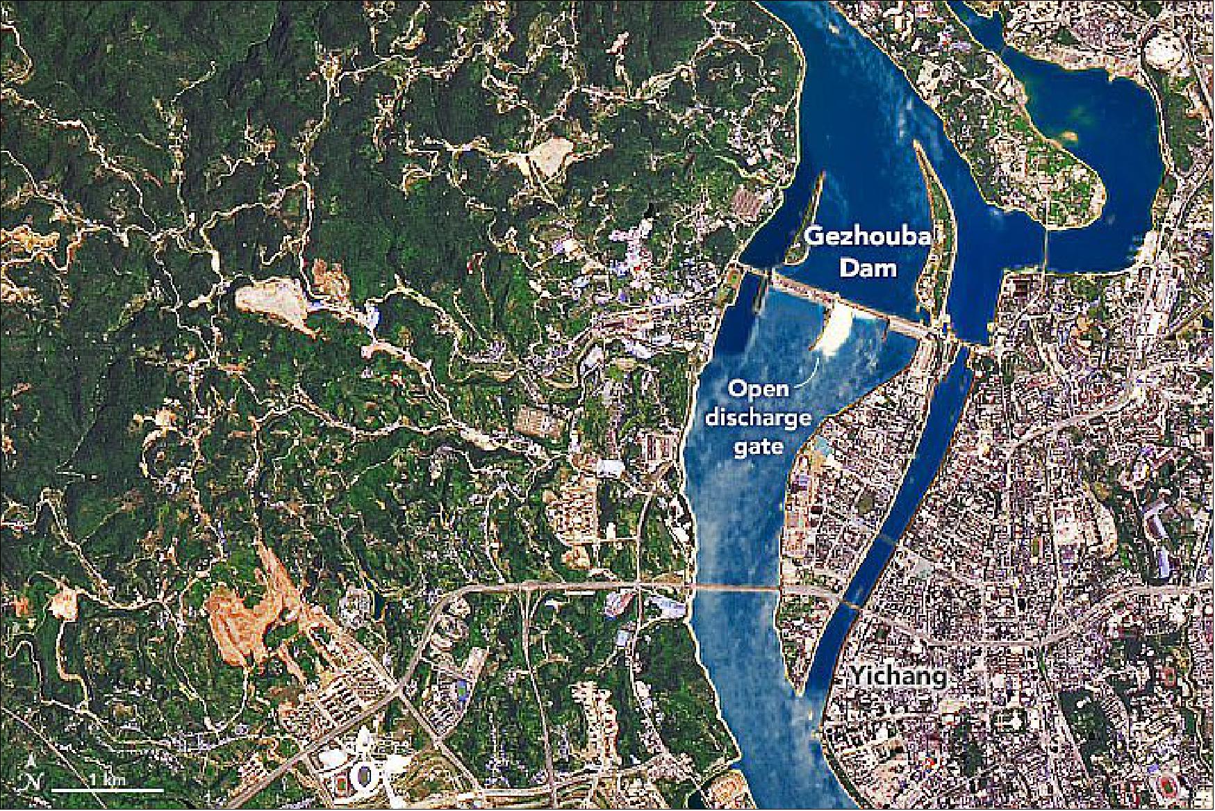 Figure 63: The image shows the smaller Gezhouba Dam, located about 26 km (16 miles) southeast from Three Gorges. This dam also appeared to have its spillway gates open (image credit: NASA Earth Observatory)