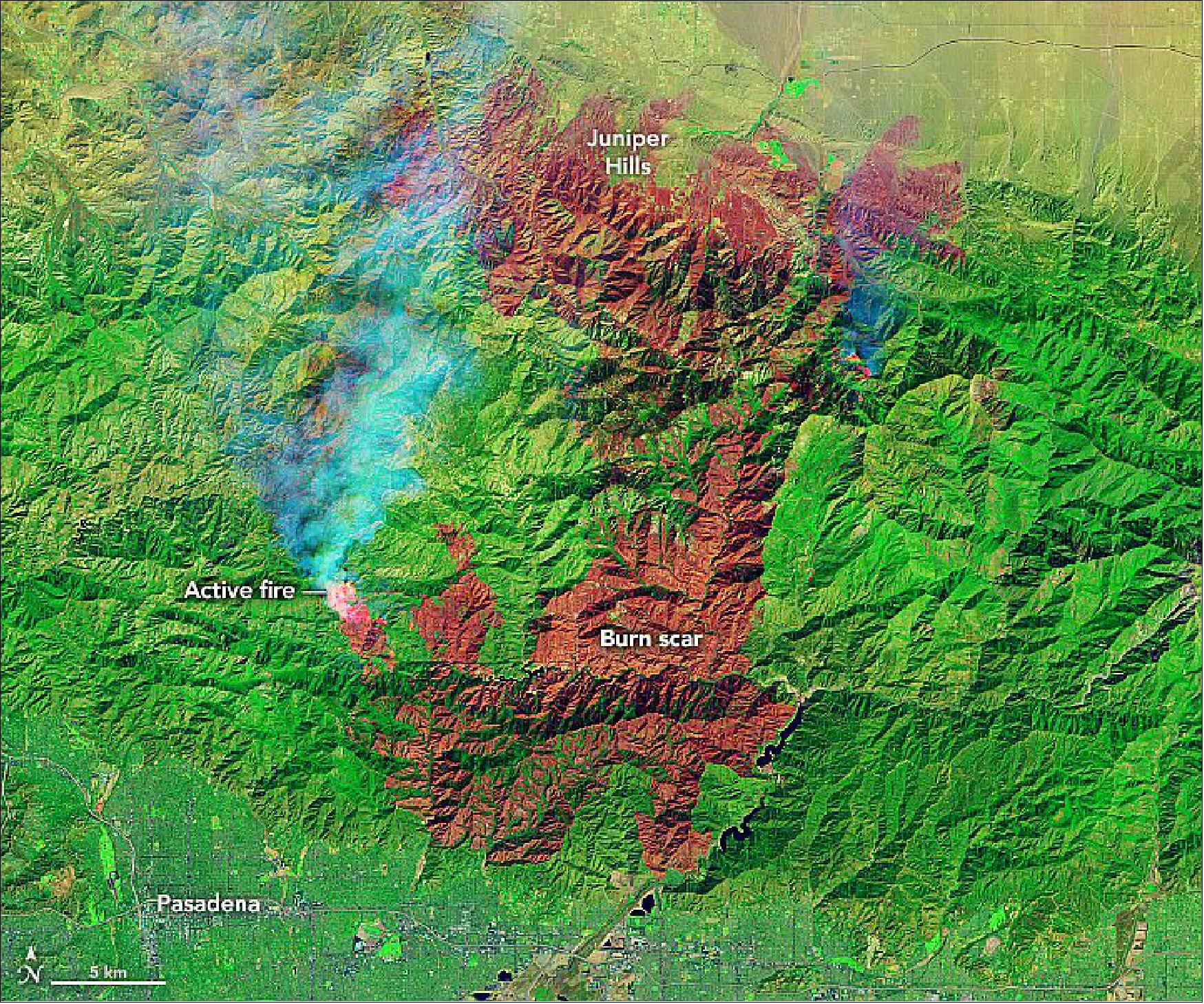 Figure 30: The fire is among the largest Los Angeles County has ever faced. Stavros and other NASA fire experts have been monitoring the blazes using a suite of satellite sensors. One of them, the OLI instrument on the Landsat-8 satellite, acquired an image of the burn scar on September 21, 2020, while the fire was still raging in Angeles National Forest. False color makes it easier to distinguish the burn scar. The image combines shortwave infrared, near-infrared, and green light (OLI bands 7-5-2) to show active fires (bright red), scarred land that has been consumed by the fire (darker red), intact vegetation (green), and cities and infrastructure (gray) [image credit: NASA Earth Observatory image by Lauren Dauphin, using Landsat data from the U.S. Geological Survey. AVIRIS photograph by Tim Williams on 21 September 2020 (NASA Armstrong Flight Research Center). Story by Adam Voiland]