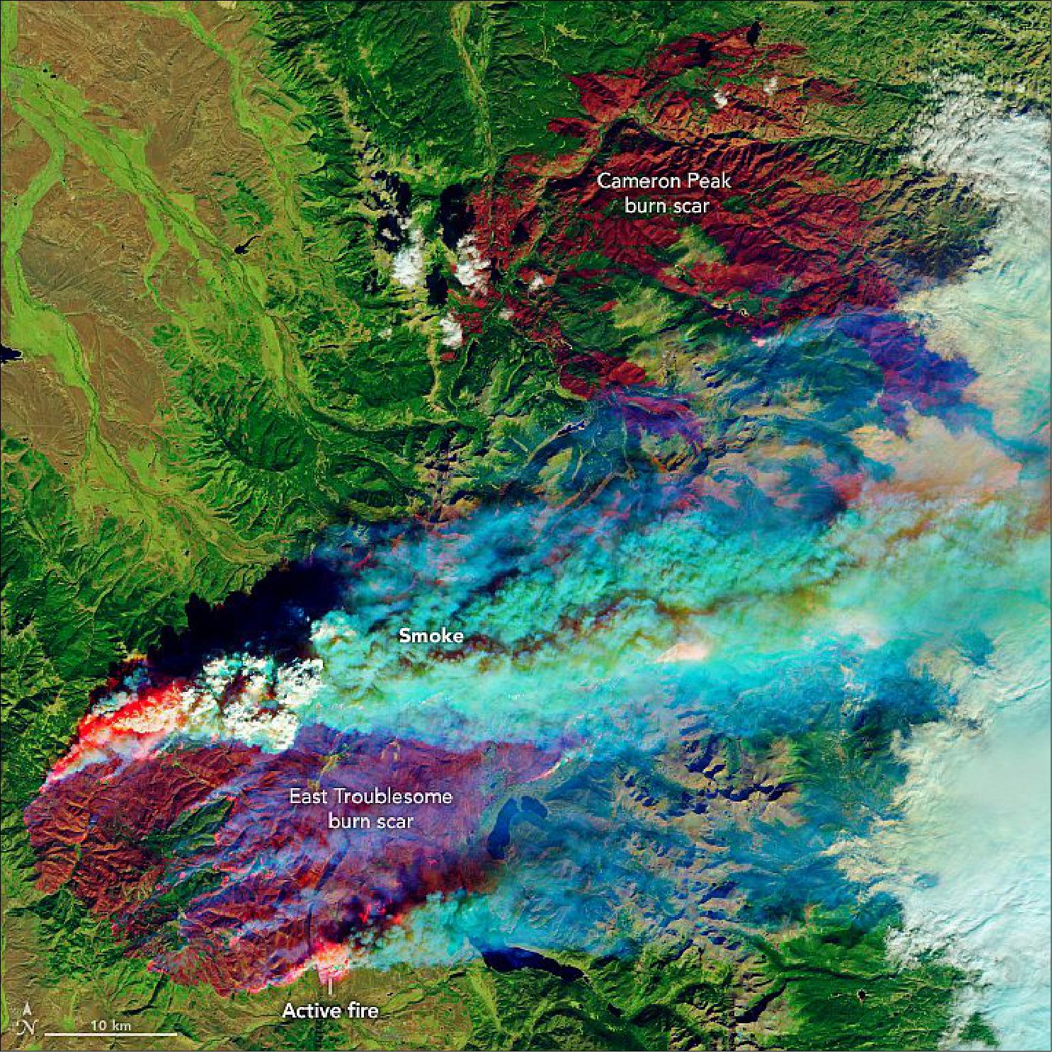 Figure 23: On October 22, OLI on Landsat-8 captured this false-color image of the East Troublesome fire. The image combines shortwave infrared, near-infrared, and green light (bands 7-5-2) to show active fires (bright red), scarred land consumed by fire (darker red), and intact vegetation (green), image credit: NASA Earth Observatory image by Lauren Dauphin, using Landsat data from the U.S. Geological Survey. Story by Kasha Patel)