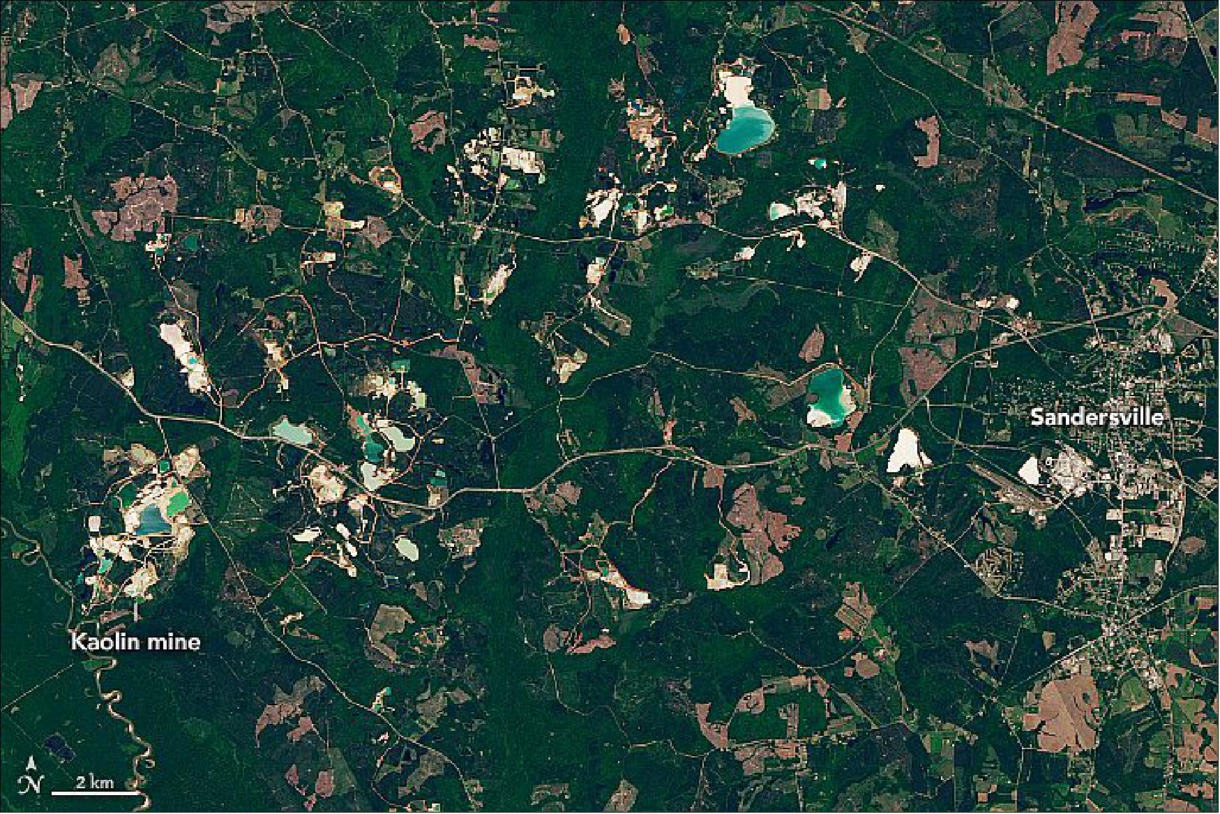 Figure 3: People have long extracted the soft clay from central Georgia for use in paper, ceramics, and other products. Signs of the industry are apparent in this natural-color satellite image, where mining pits appear white. Rain has collected in many of the pits, forming ponds with a crystal blue color. Some of the forested areas around the active pits were mined in previous decades but have since been replanted with trees and other vegetation. The Operational Land Imager (OLI) on Landsat-8 captured this image on April 13, 2020 (image credit: NASA Earth Observatory image by Lauren Dauphin, using Landsat data from the U.S. Geological Survey. Story by Adam Voiland)