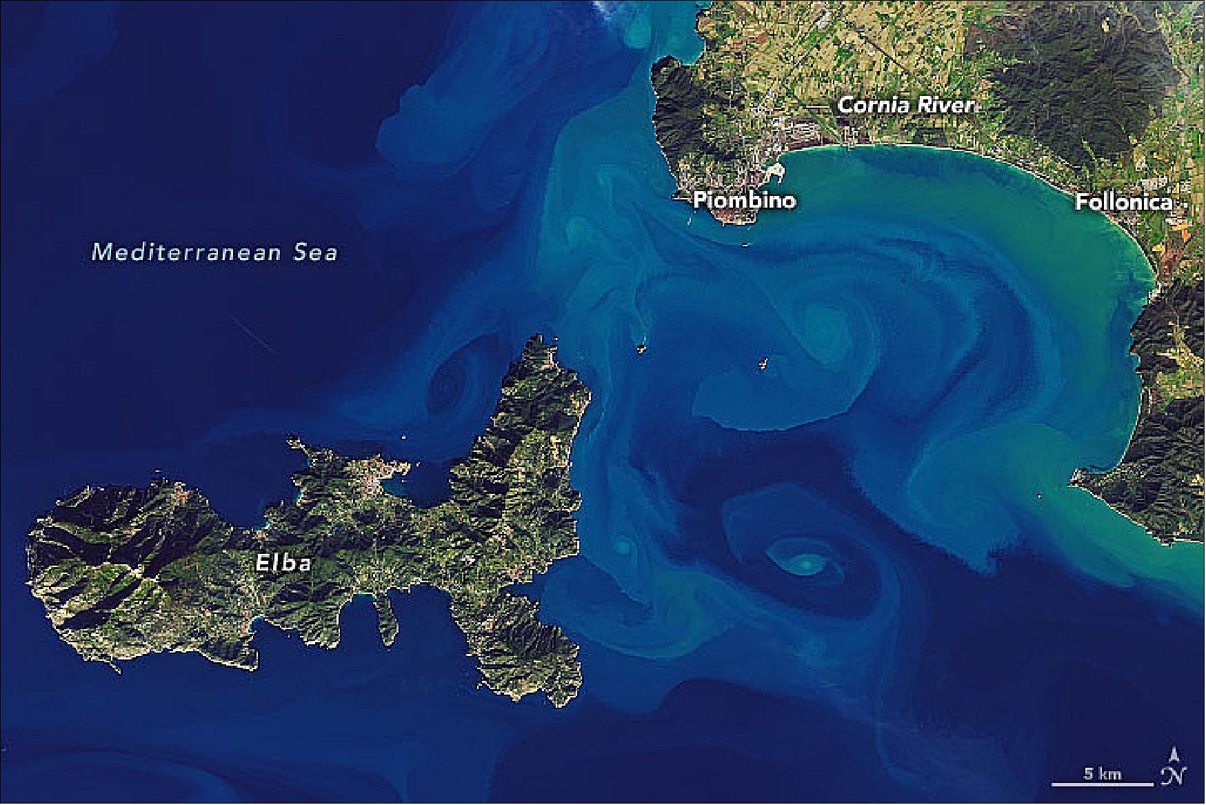 Figure 125: Aida Alvera-Azcárate, an ocean scientist at University of Liège, noticed colorful swirls off the coast of western Italy starting in late December 2019, as observed by the European Space Agency’s Sentinel-3 and Sentinel-2 satellites. The Operational Land Imager (OLI) on Landsat 8 acquired a similar scene on December 26 (top) showing colorful waters between the island of Elba and the Italian mainland (image credit: NASA Earth Observatory, image by Joshua Stevens, using Landsat data from the U.S. Geological Survey. Story by Kathryn Hansen)