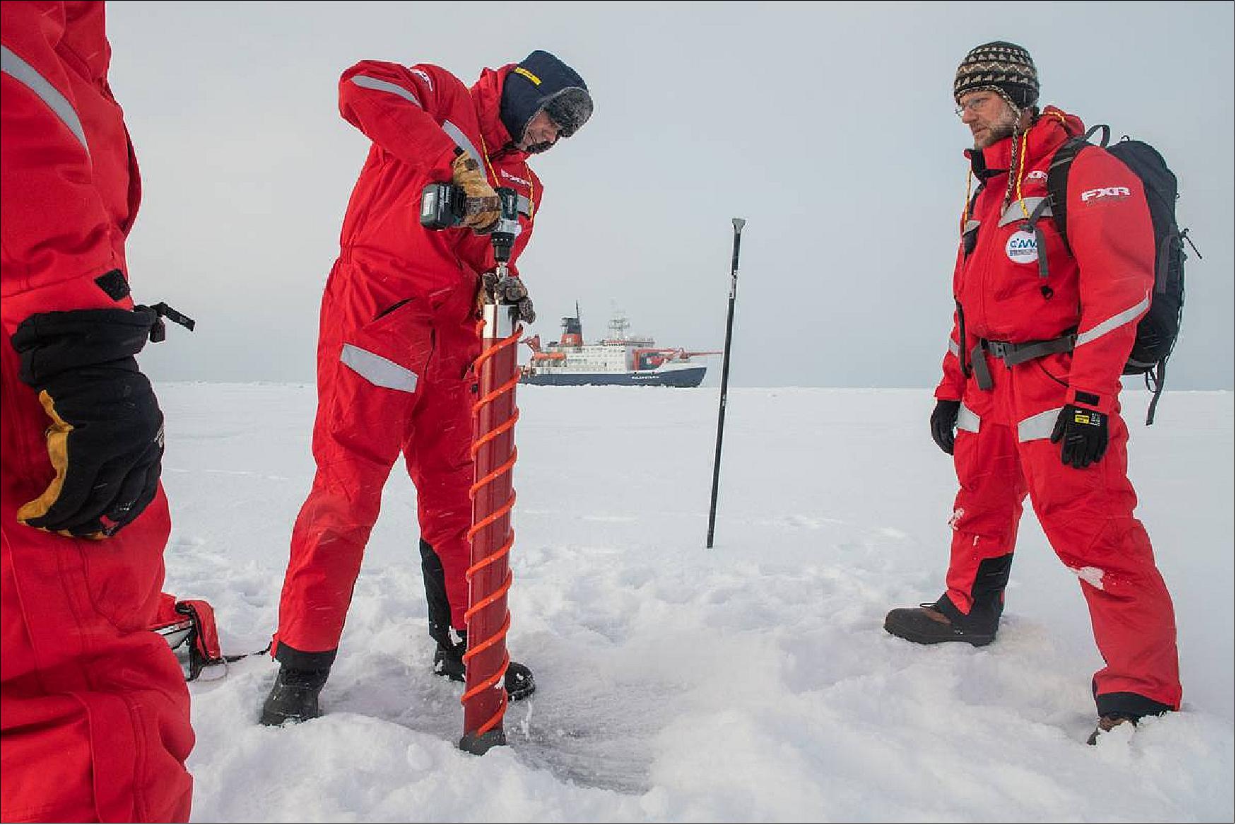 Figure 55: First group of scientists lands on an ice floe. Gunnar Spreen (left) and Matthew Shupe (right) examine a potential ice floe for MOSAiC on 30 September 2019, (photo credit: AWI, Esther Horvath)