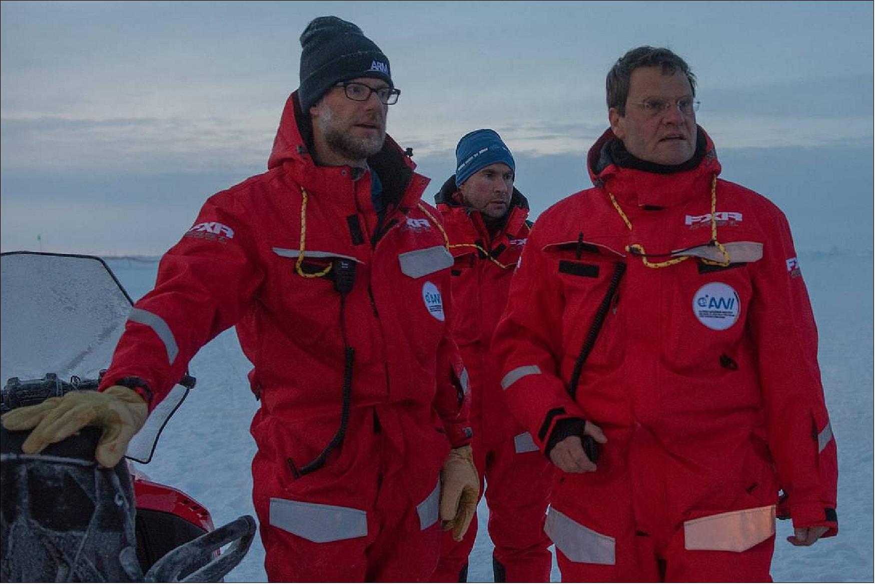 Figure 11: Markus Rex (r), Matthew Shupe (l) and Marcel Nicolaus front of Polarstern on the ice floe. October 9, 2019 (photo credit: Esther Horvath, Alfred-Wegener-Institut, Helmhol)