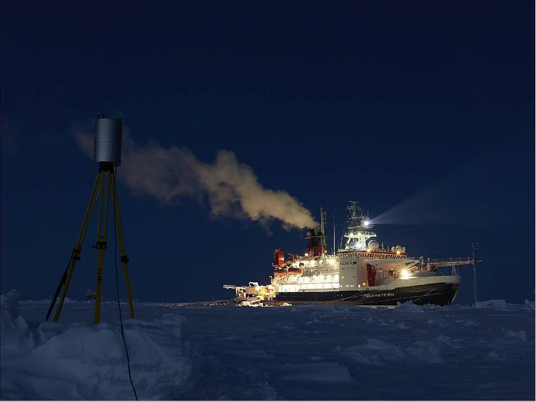 Figure 9: The terrestrial laser scanner (TLS) creates 3D laser scans of the land-/snowscape on the MOSAiC ice floe. The scans allow investigating changes in ice and snow conditions by measuring e.g. wind driven height changes of the snow or ridge formation of the ice (photo credit: Matthias Jaggi)
