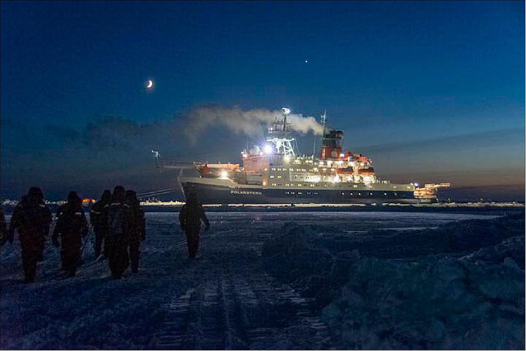 Figure 42: Scientists from MOSAiC Leg 3 walk from the Kapitan Dranitsyn to their new home on Polarstern (photo credit: NASA, Steven Fons)