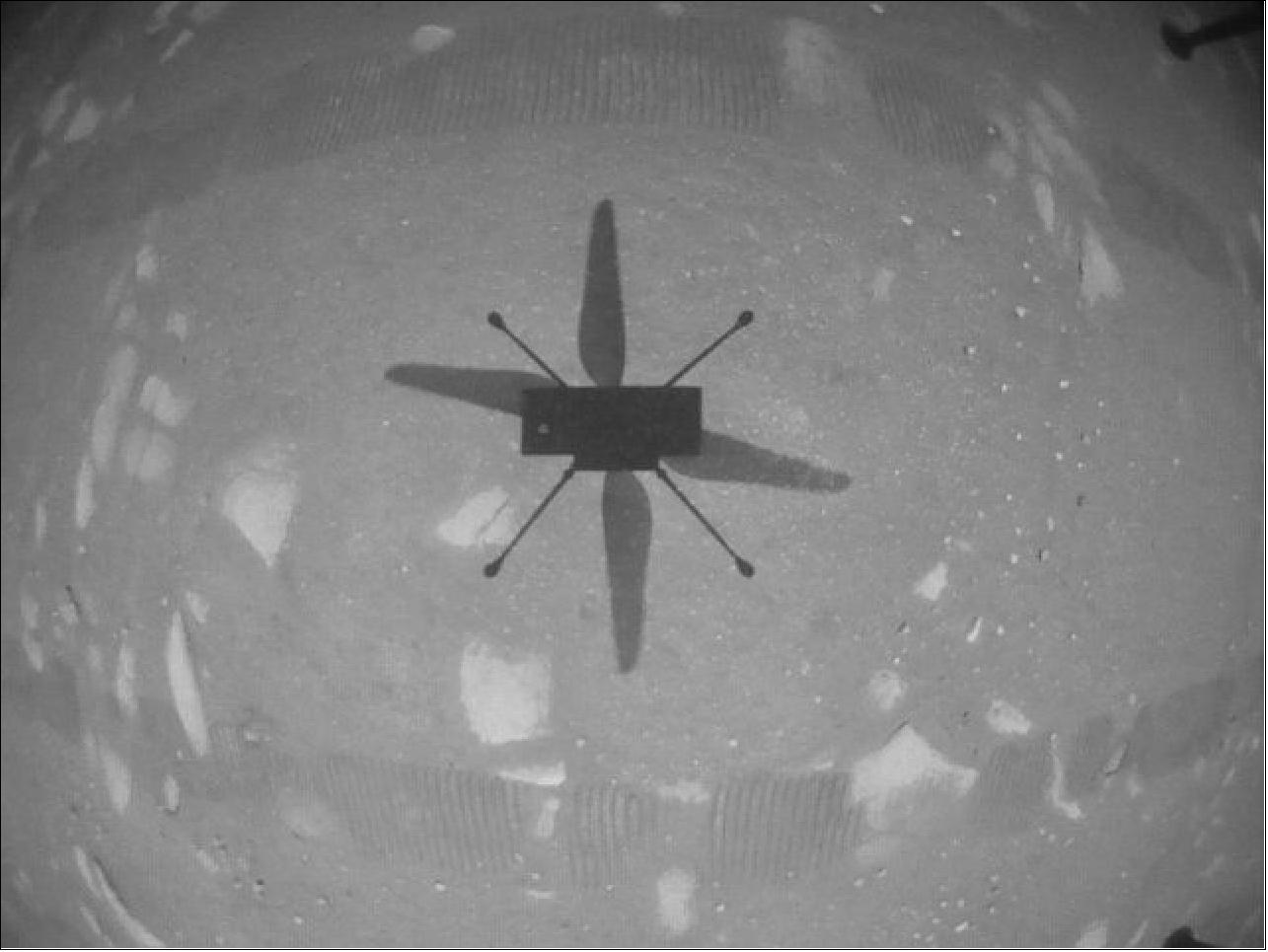 Figure 36: NASA's Ingenuity Mars Helicopter took this shot, capturing its own shadow, while hovering over the Martian surface on April 19, 2021, during the first instance of powered, controlled flight on another planet. It used its navigation camera, which autonomously tracks the ground during flight (image credit: NASA/JPL-Caltech)