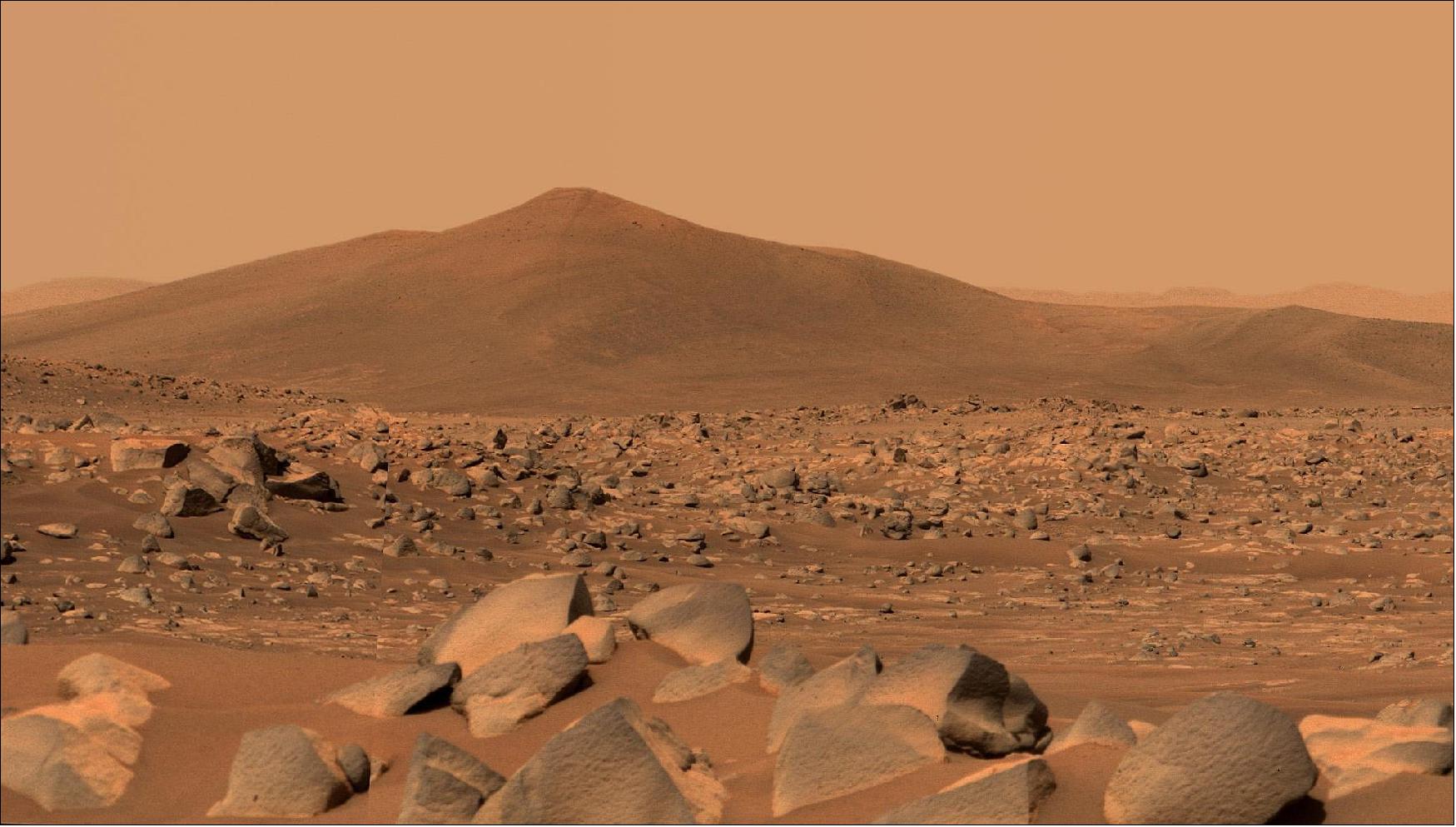 Figure 28: NASA's Perseverance Mars rover used its dual-camera Mastcam-Z imager to capture this image of "Santa Cruz," a hill about 1.5 miles (2.5 kilometers) away from the rover, on April 29, 2021, the 68th Martian day, or sol, of the mission. The entire scene is inside of Mars' Jezero Crater; the crater's rim can be seen on the horizon line beyond the hill. This scene is not white balanced; instead, it is displayed in a preliminary calibrated version of a natural-color composite, approximately simulating the colors of the scene as it would appear to a person on Mars. Arizona State University in Tempe leads the operations of the Mastcam-Z instrument, working in collaboration with Malin Space Science Systems in San Diego (image credit: NASA/JPL-Caltech/ASU/MSSS)