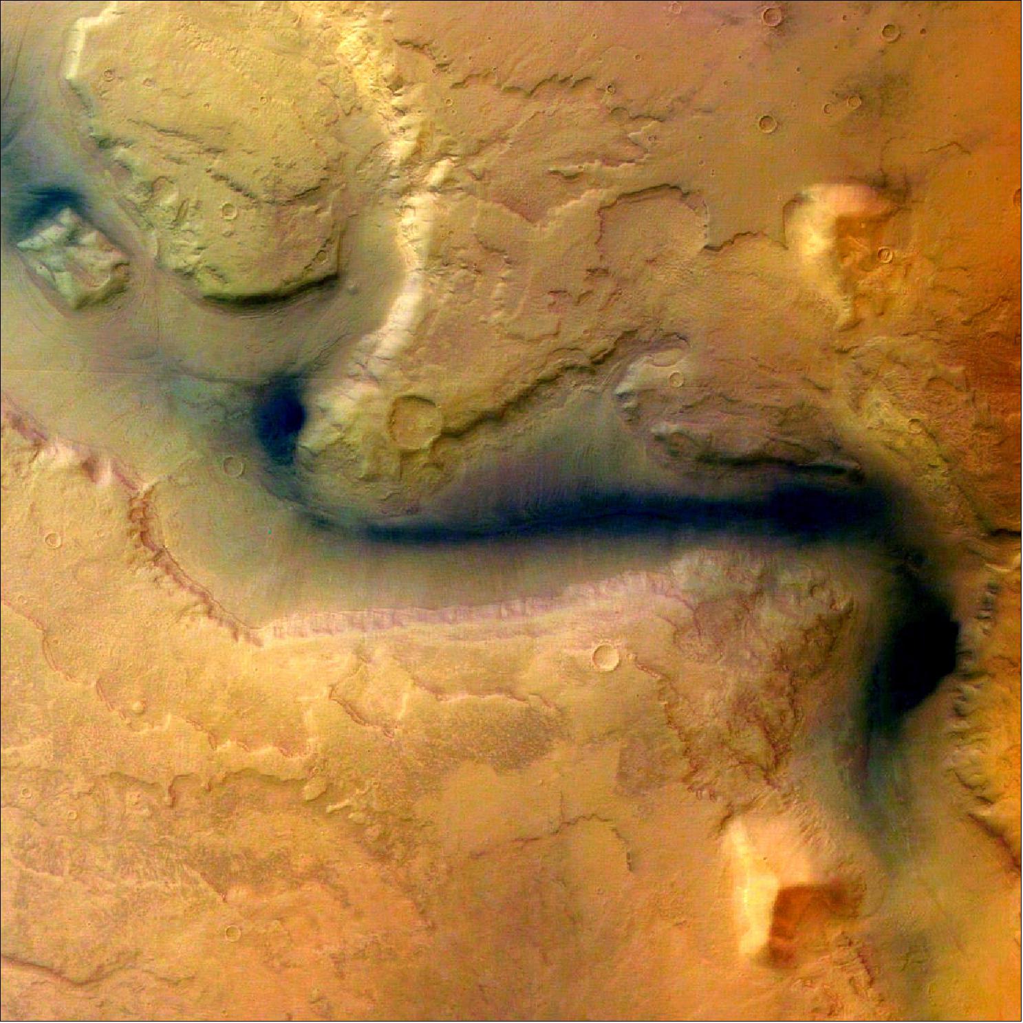 Figure 91: This picture was taken by the High Resolution Stereo Camera (HRSC) onboard ESA's Mars Express orbiter, in color and 3D, in orbit 18 on 15 January 2004 from a height of 273 km. The location is east of the Hellas basin at 41º South and 101º East. The area is 100 km across, with a resolution of 12 m per pixel, and shows a channel (Reull Vallis) once formed by flowing water. The landscape is seen in a vertical view, North is at the top (image credit: ESA/DLR/FU Berlin (G. Neukum), CC BY-SA 3.0 IGO)